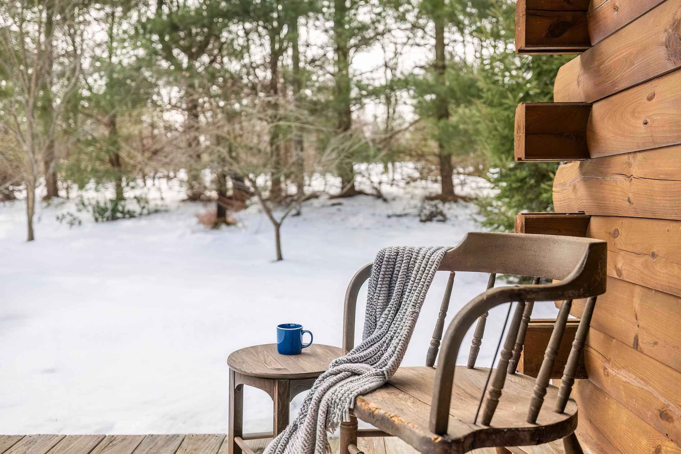 County Line Cabin’s covered porch offers a spot for morning coffee with winter views.