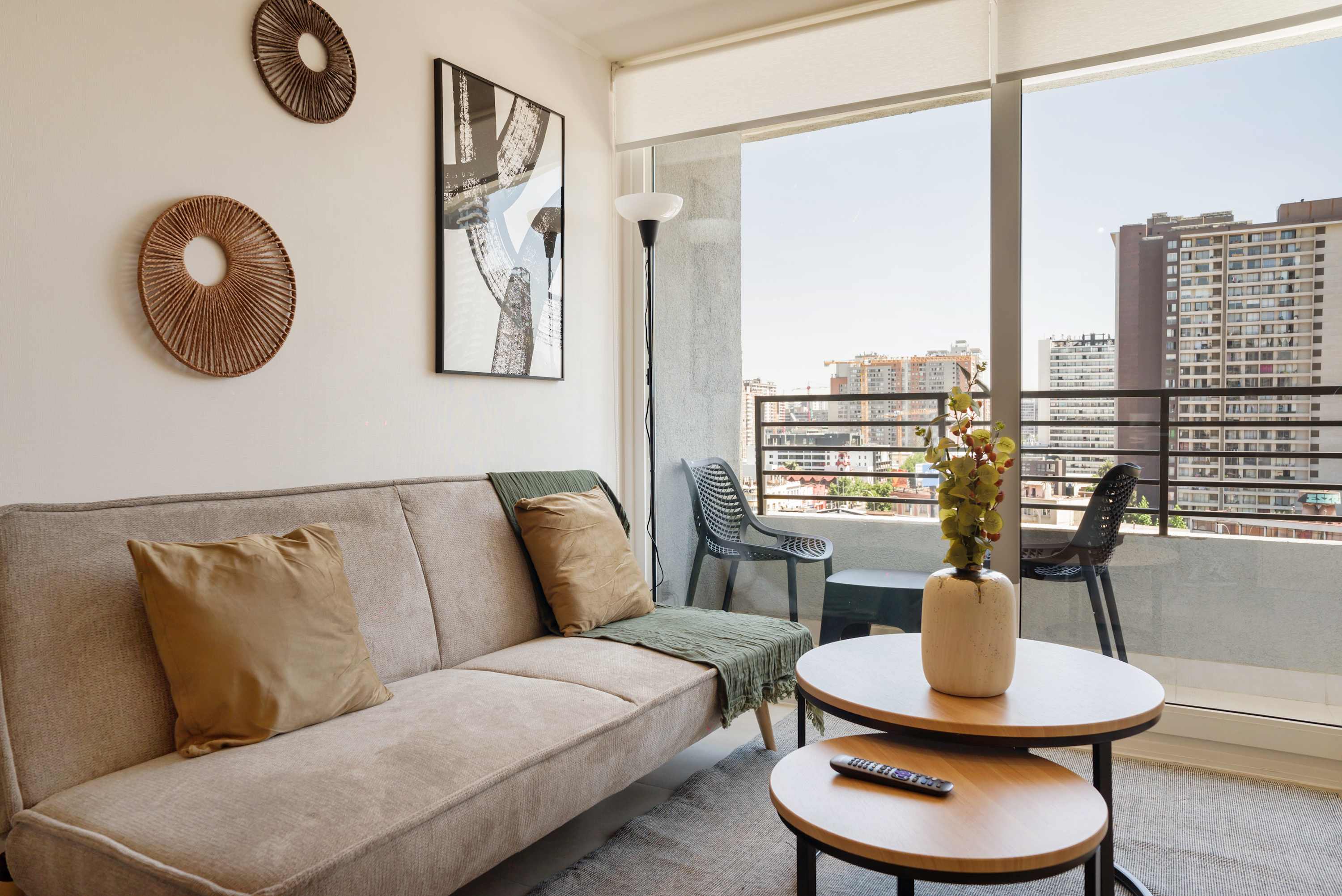 Private living room with a comfortable sectional, layered coffee tables, and floor-to-ceiling windows overlooking the city.