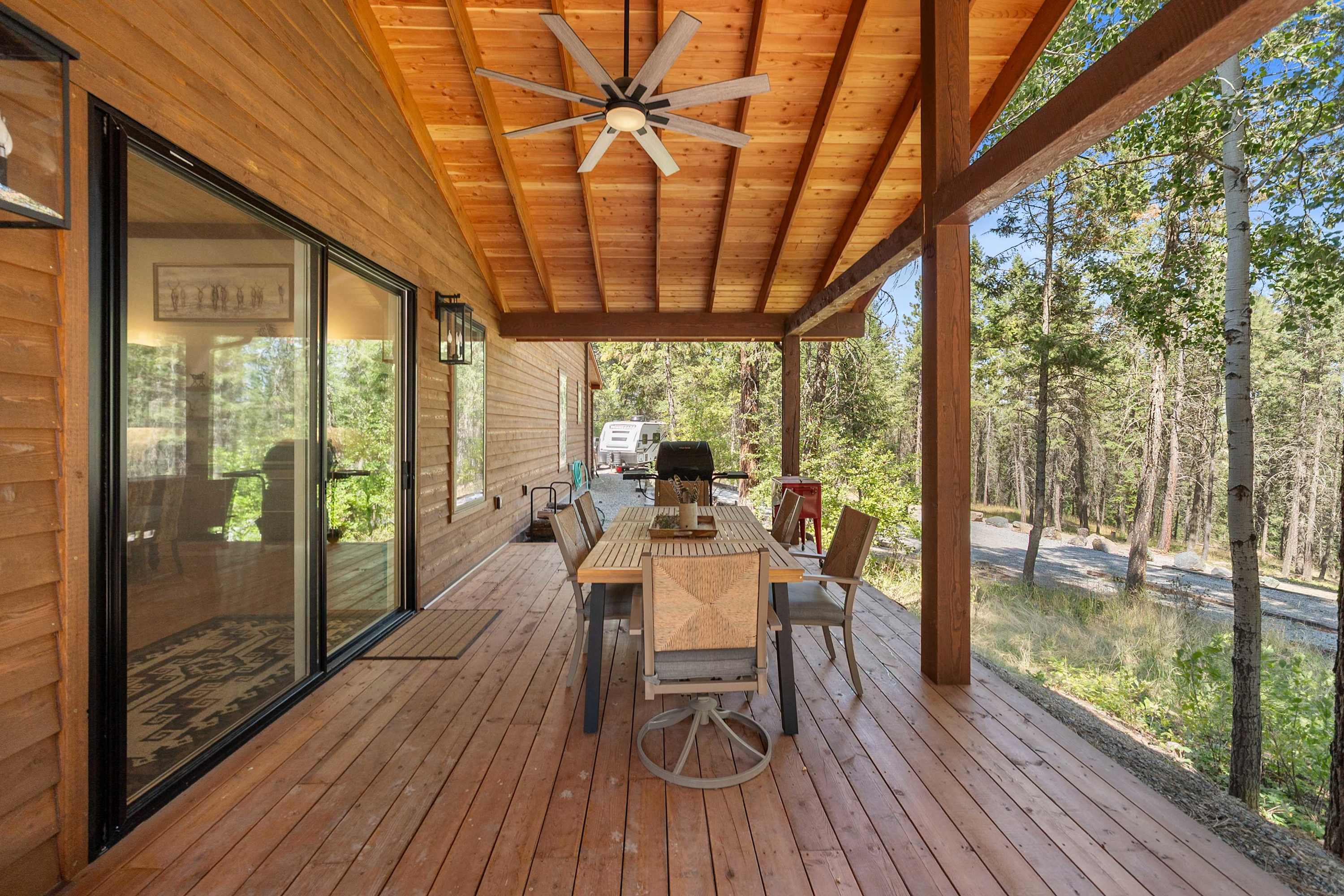 A covered outdoor retreat with seating for enjoying the surrounding scenery