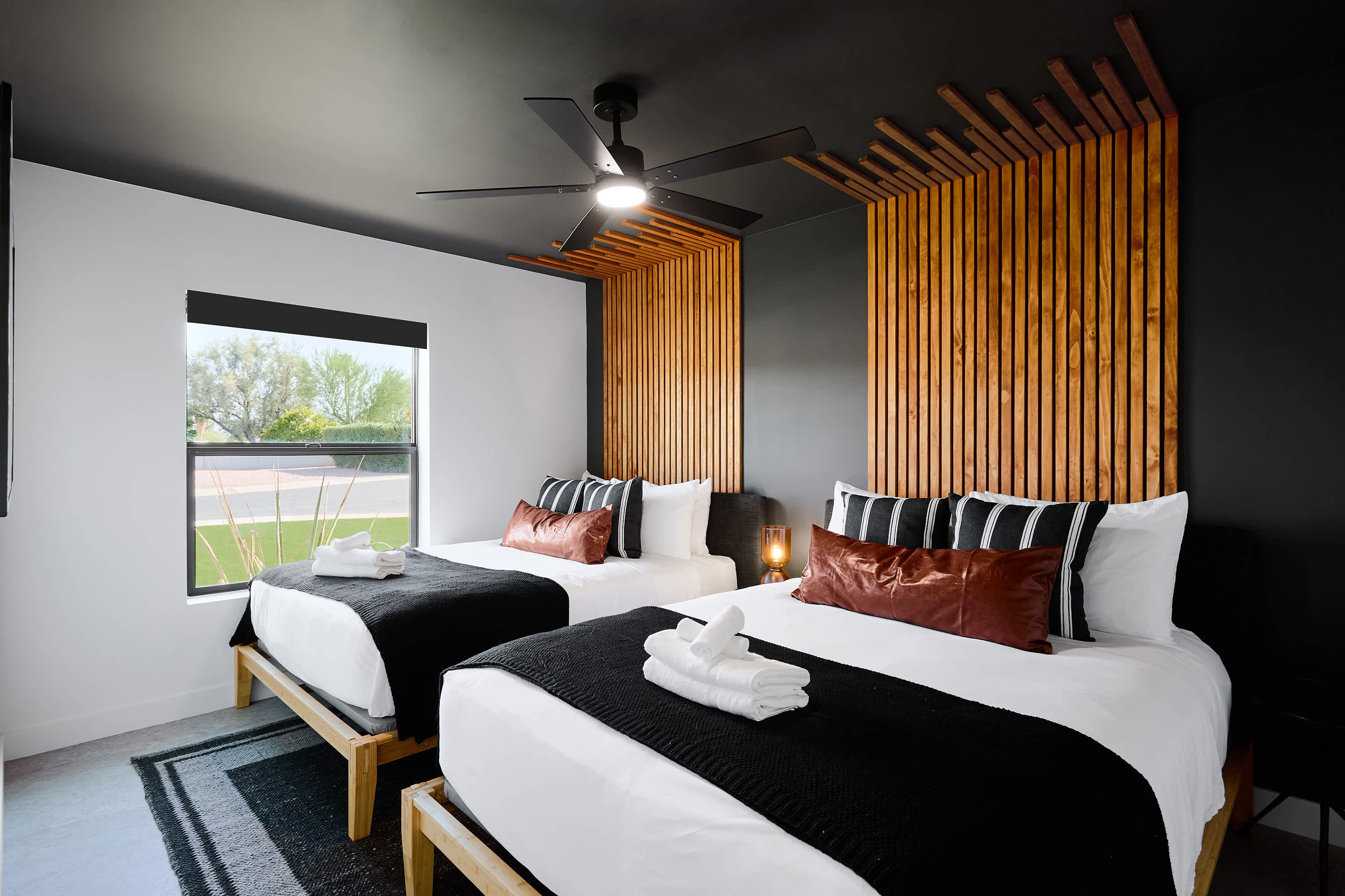 3rd bedroom with 2 Queen beds, designer furnishings, smart TV, and ceiling fan.