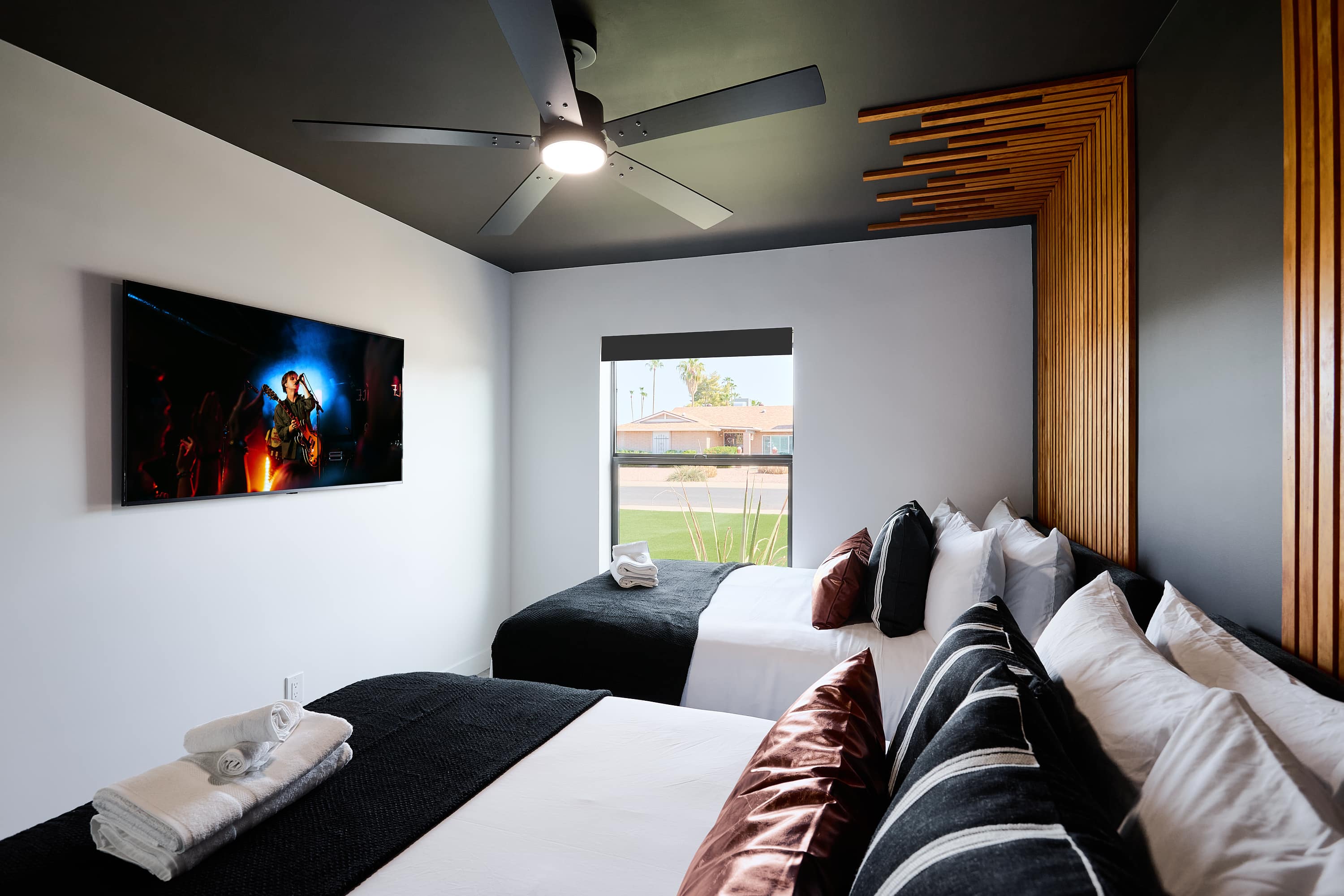 3rd bedroom with 2 Queen beds, designer furnishings, smart TV, and ceiling fan.