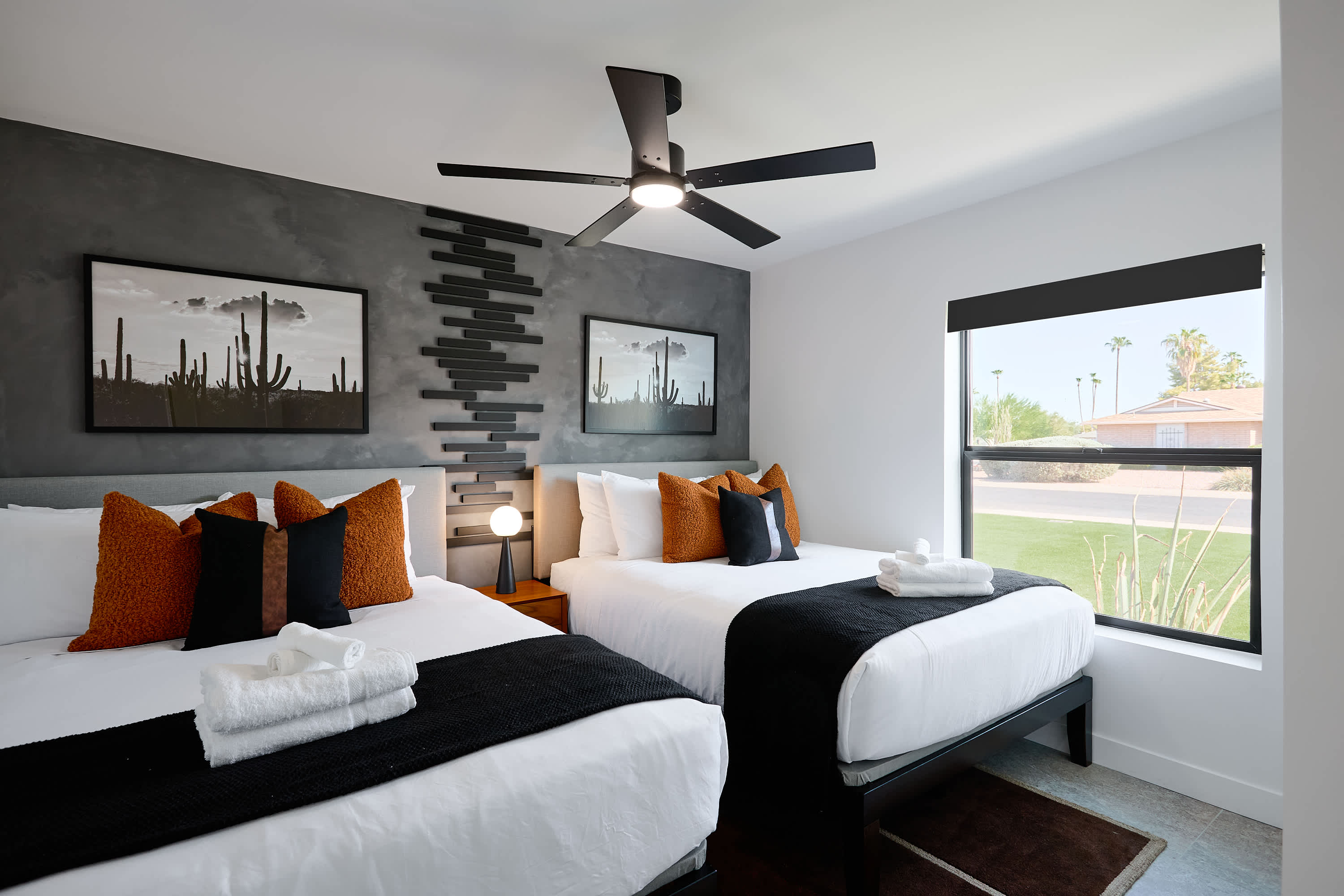 4th bedroom with 2 Queen beds, ceiling fan, and designer furnishings.