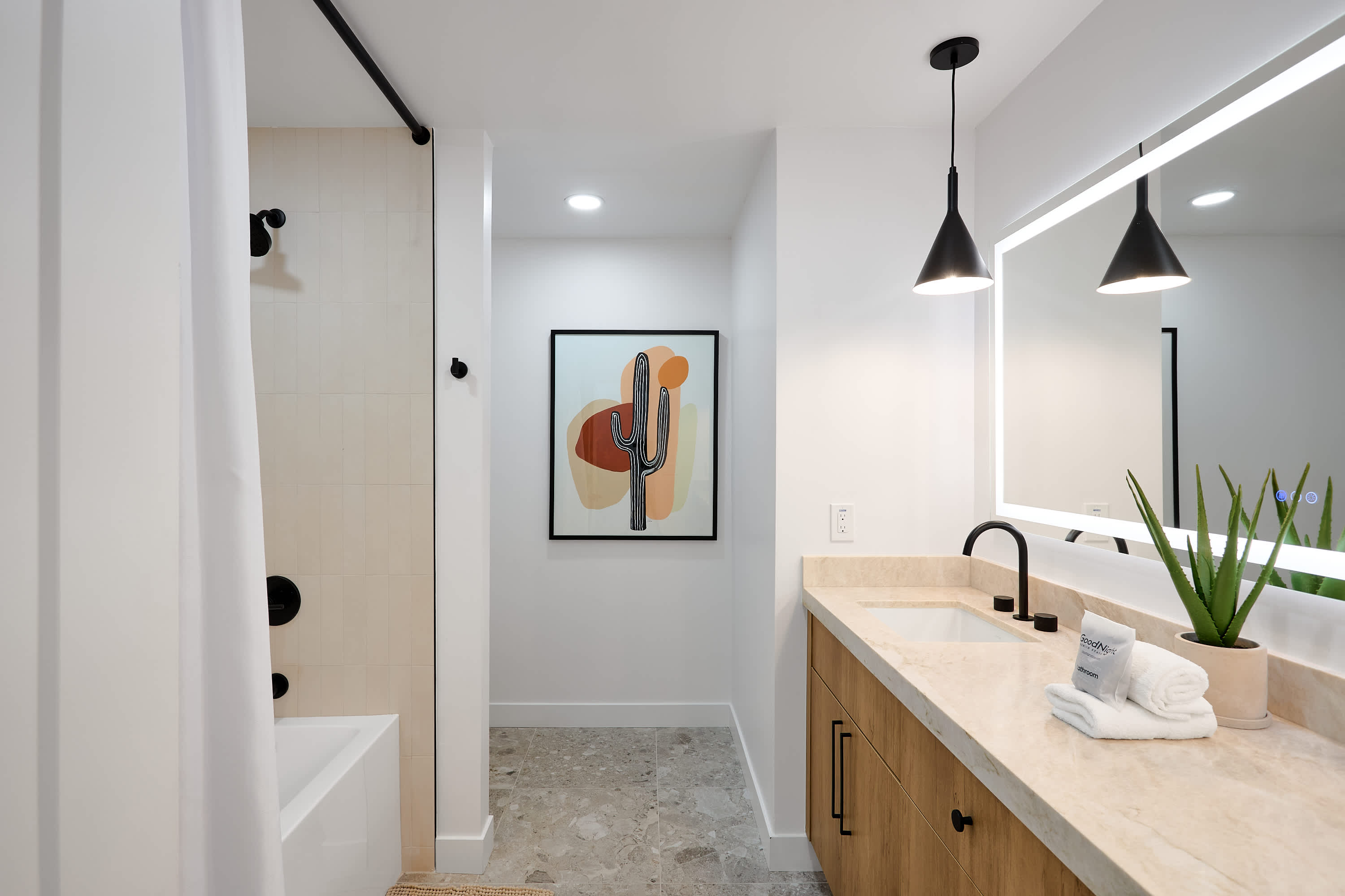 2nd bathroom with dual vanity sinks and shower/tub combo.