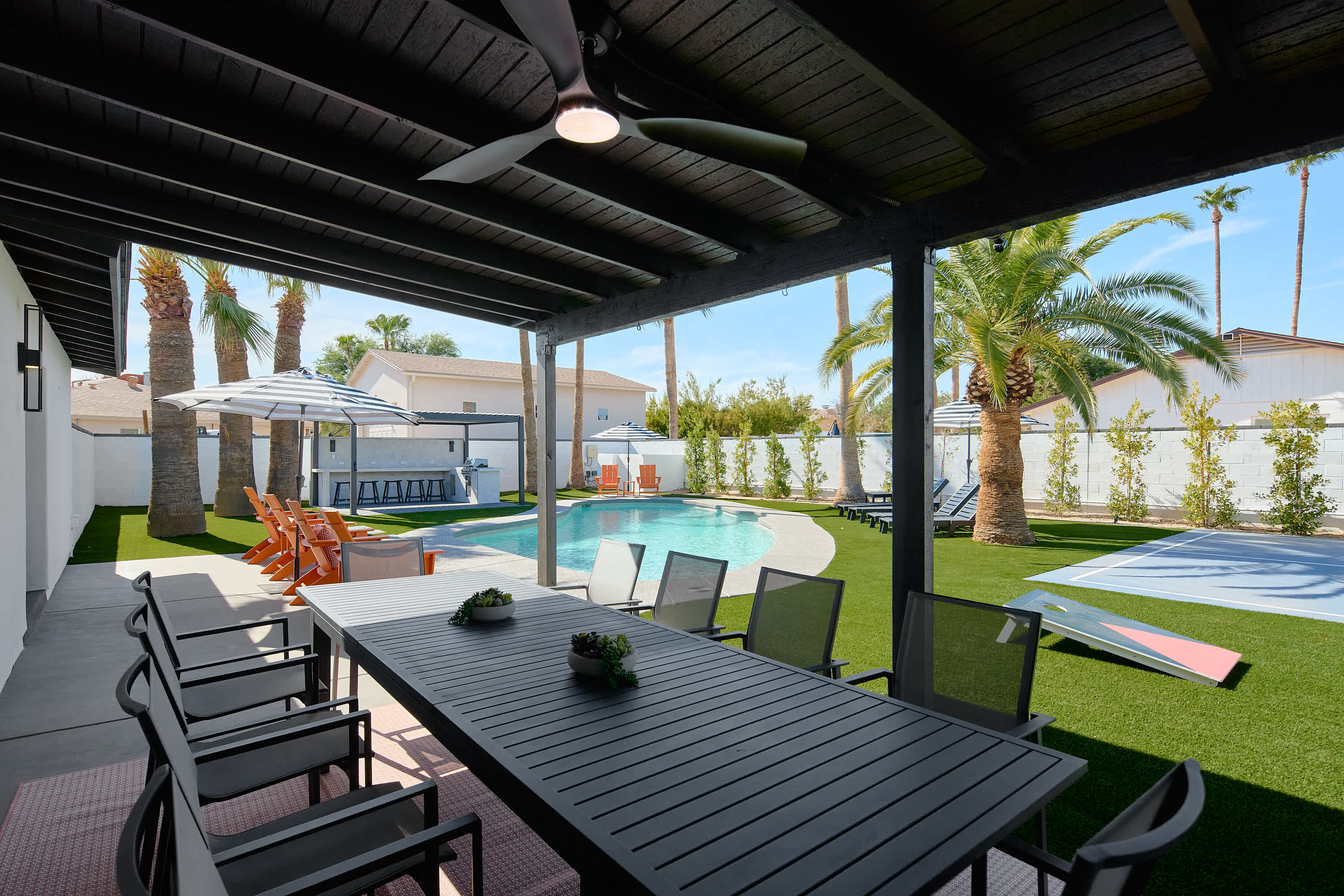 Covered patio with ceiling fans and outdoor dining table for 10