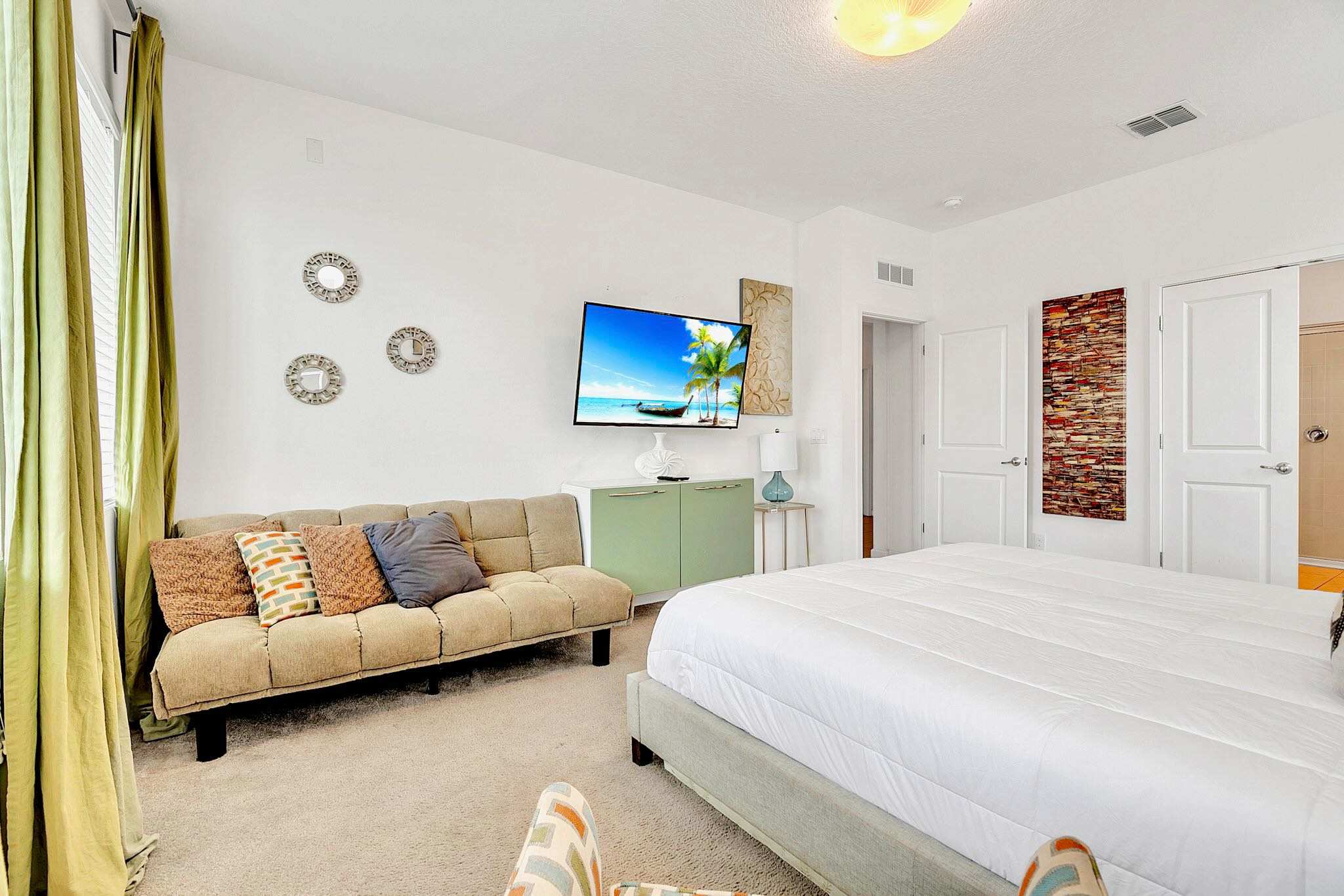 Unwind in the spacious Master Suite, complete with a plush King bed, cozy seating area, and flat-screen TV.