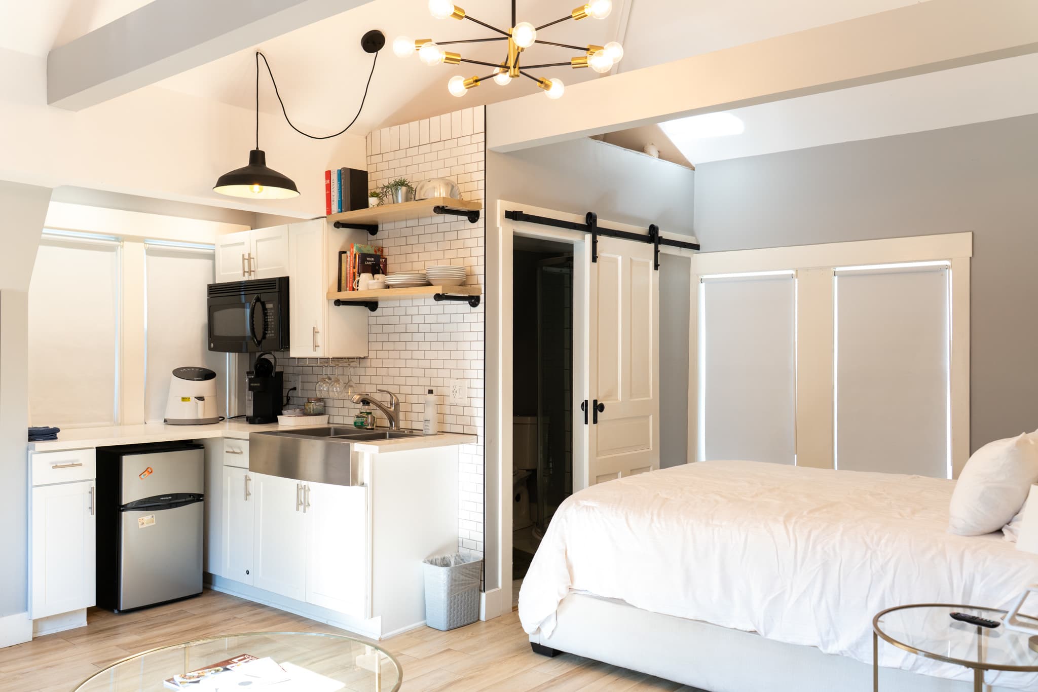 Settle into this airy carriage house, where a cozy bed, charming kitchenette, and vaulted ceiling create an inviting retreat.