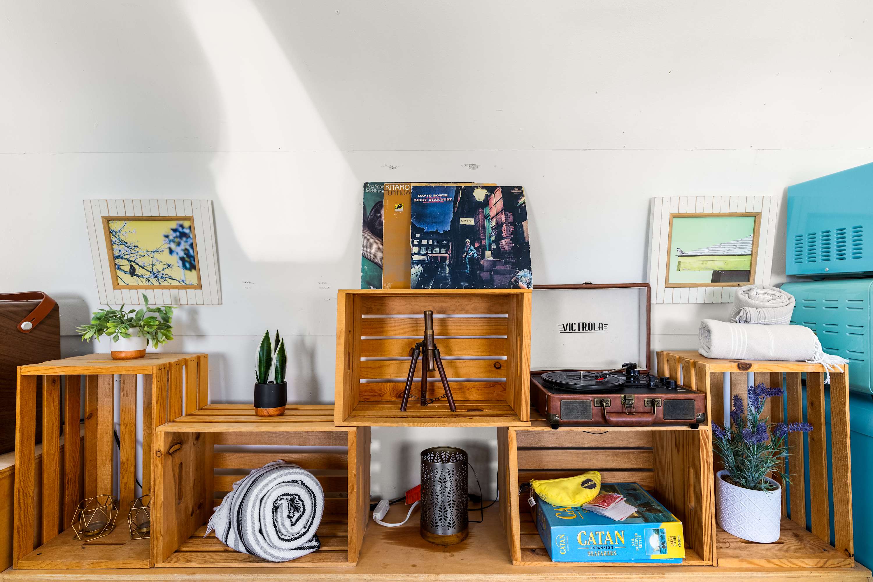 Wood crate shelving in the Airstream with a record player, records, books and storage.