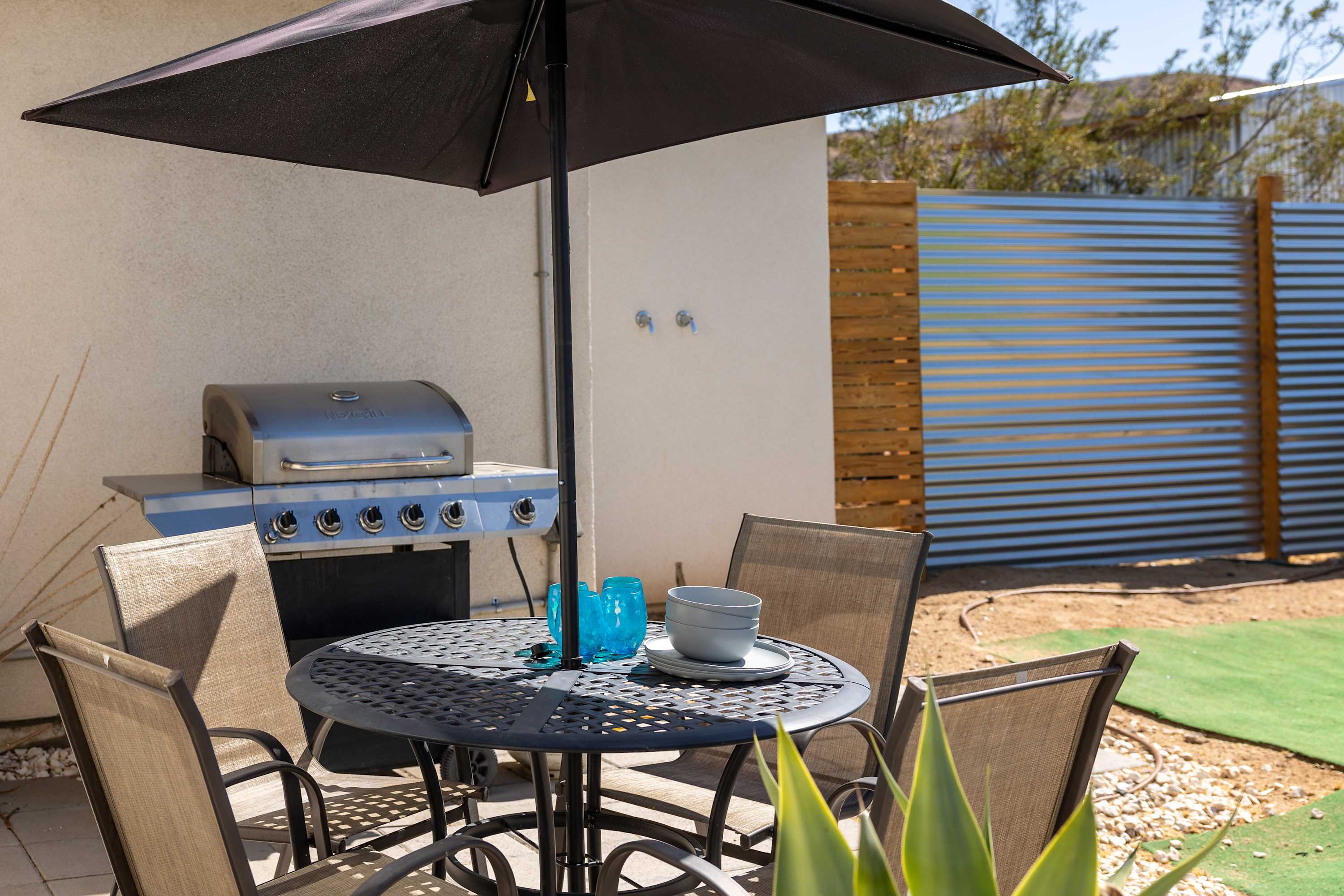 Outdoor dining table and grill station beside the studio courtyard.