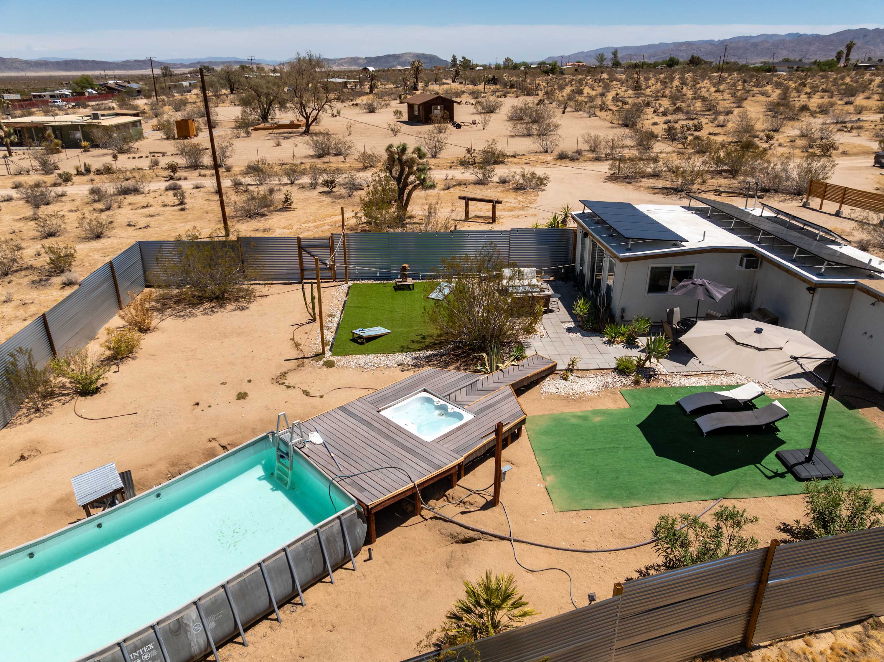 Aerial view of Studio House Zone of the compound, secured with privacy corrugated metal walls.