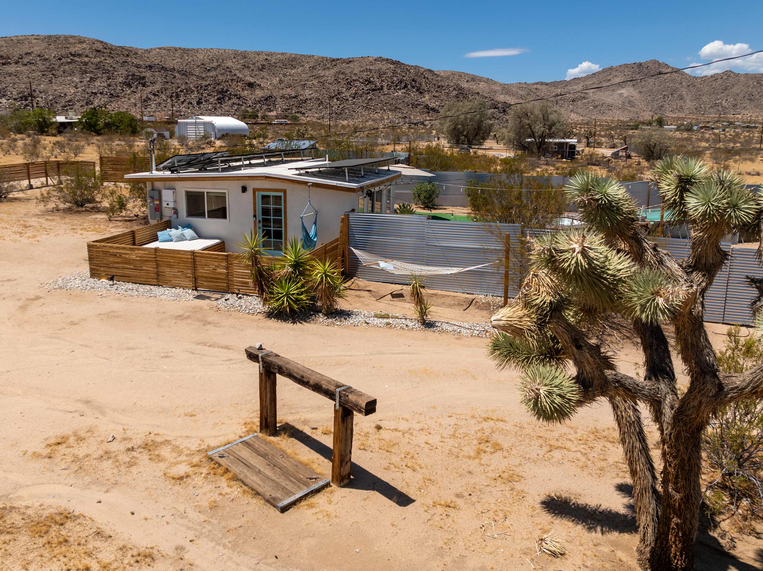 Studio exterior and courtyard entrance amid desert landscaping.