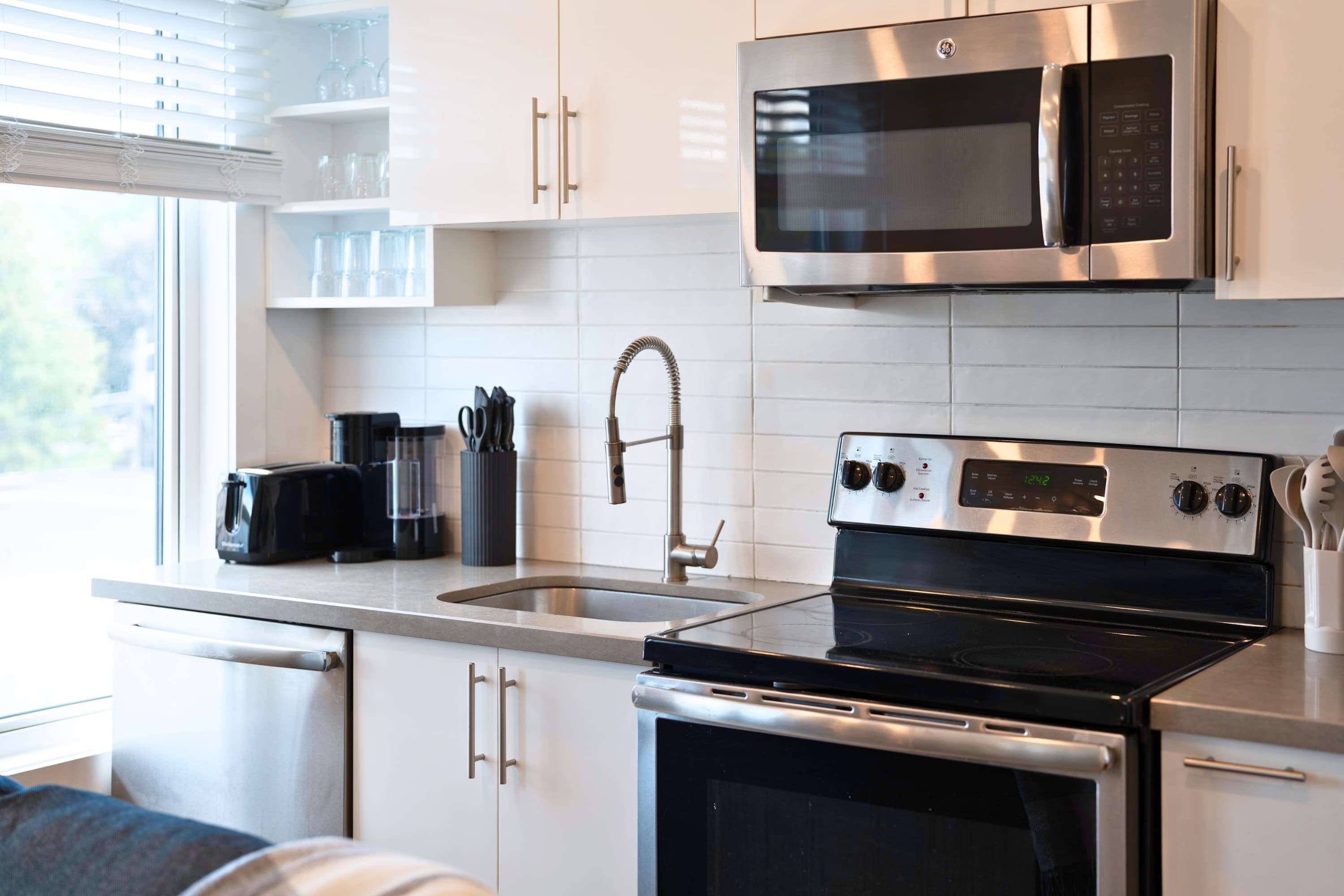 Includes dishwasher, microwave, and deep sink for easy kitchen cleanup.