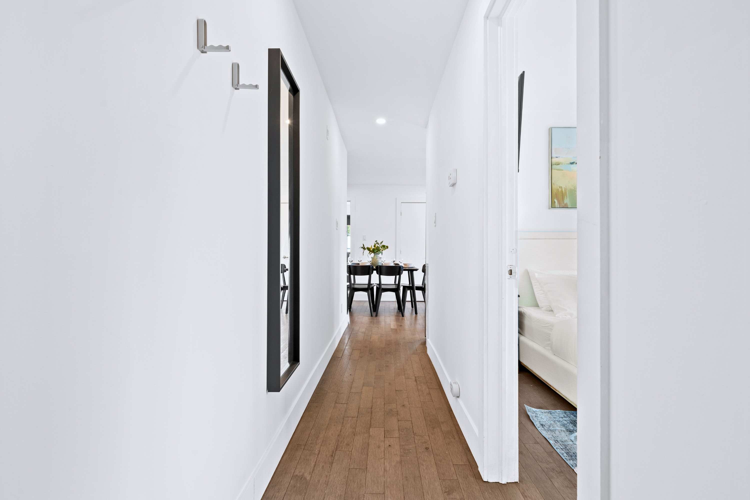 Seamless hallway finish separating private quarters from main spaces.