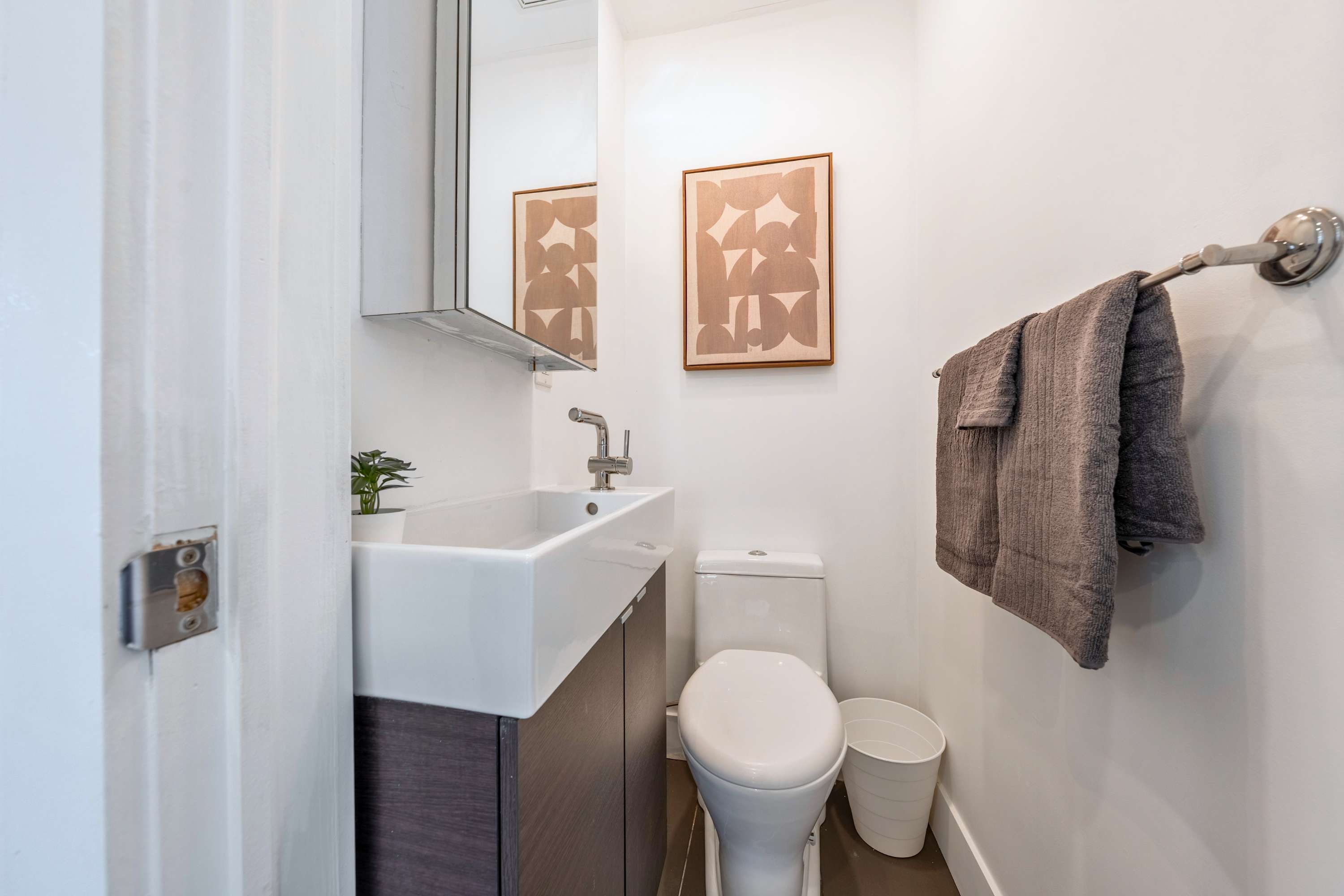 Sleek half-bath powder room for added convenience during group stays.