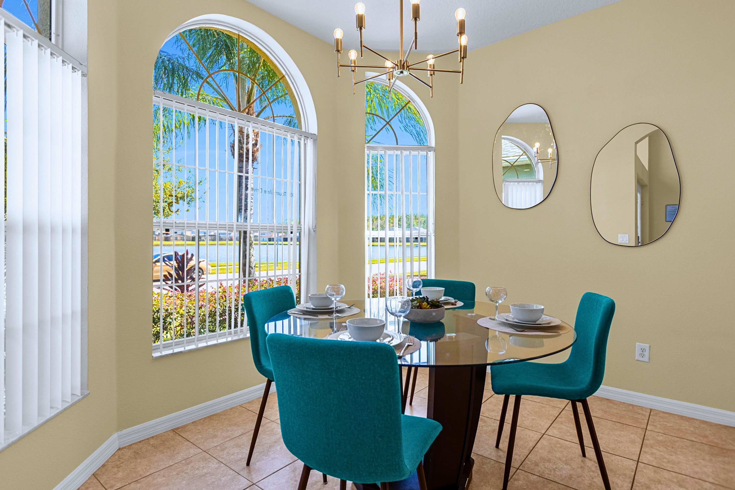 Enjoy morning views at this round glass table for 4 with chandelier