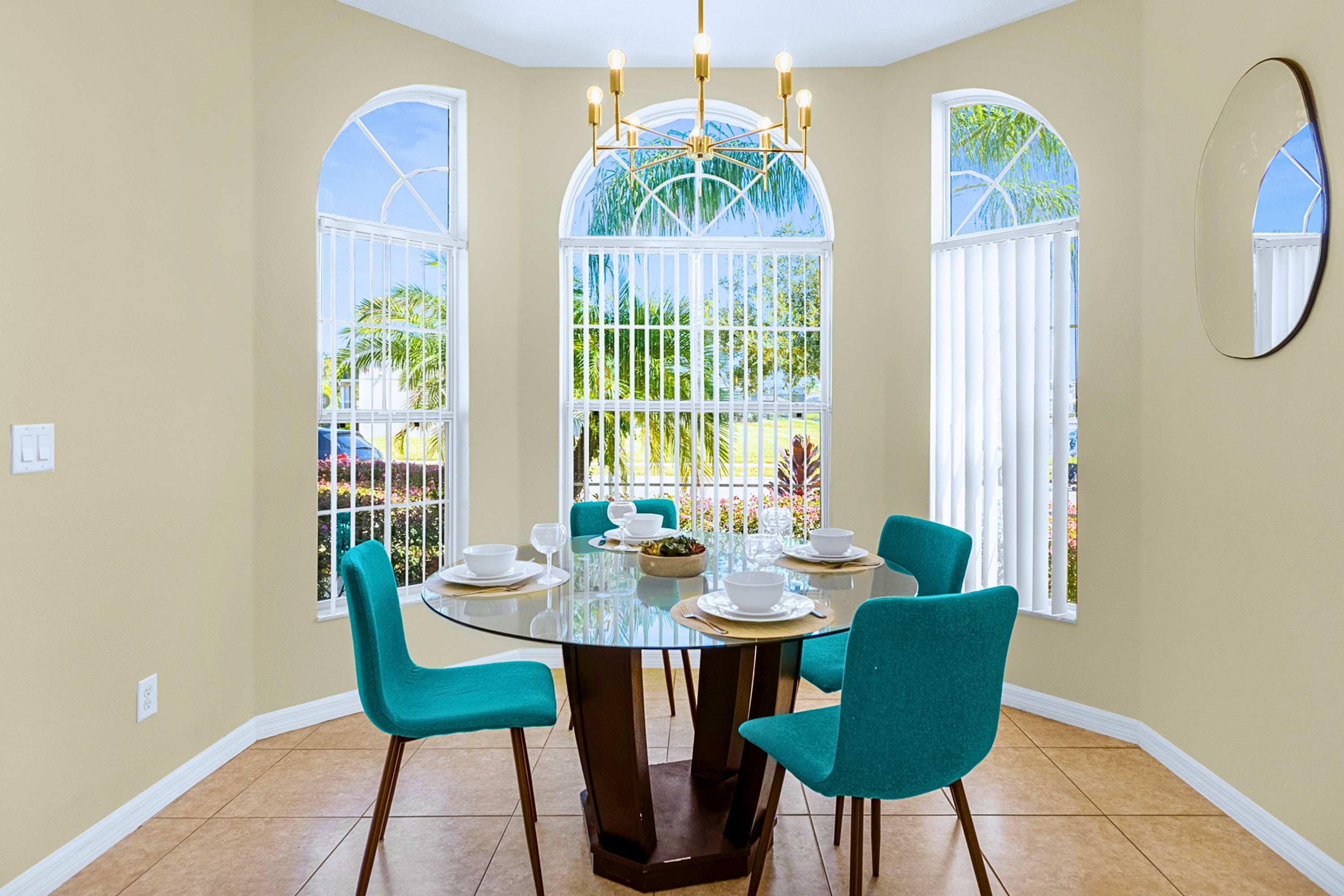 Intimate round glass dining corner for 4 with stylish decor and views