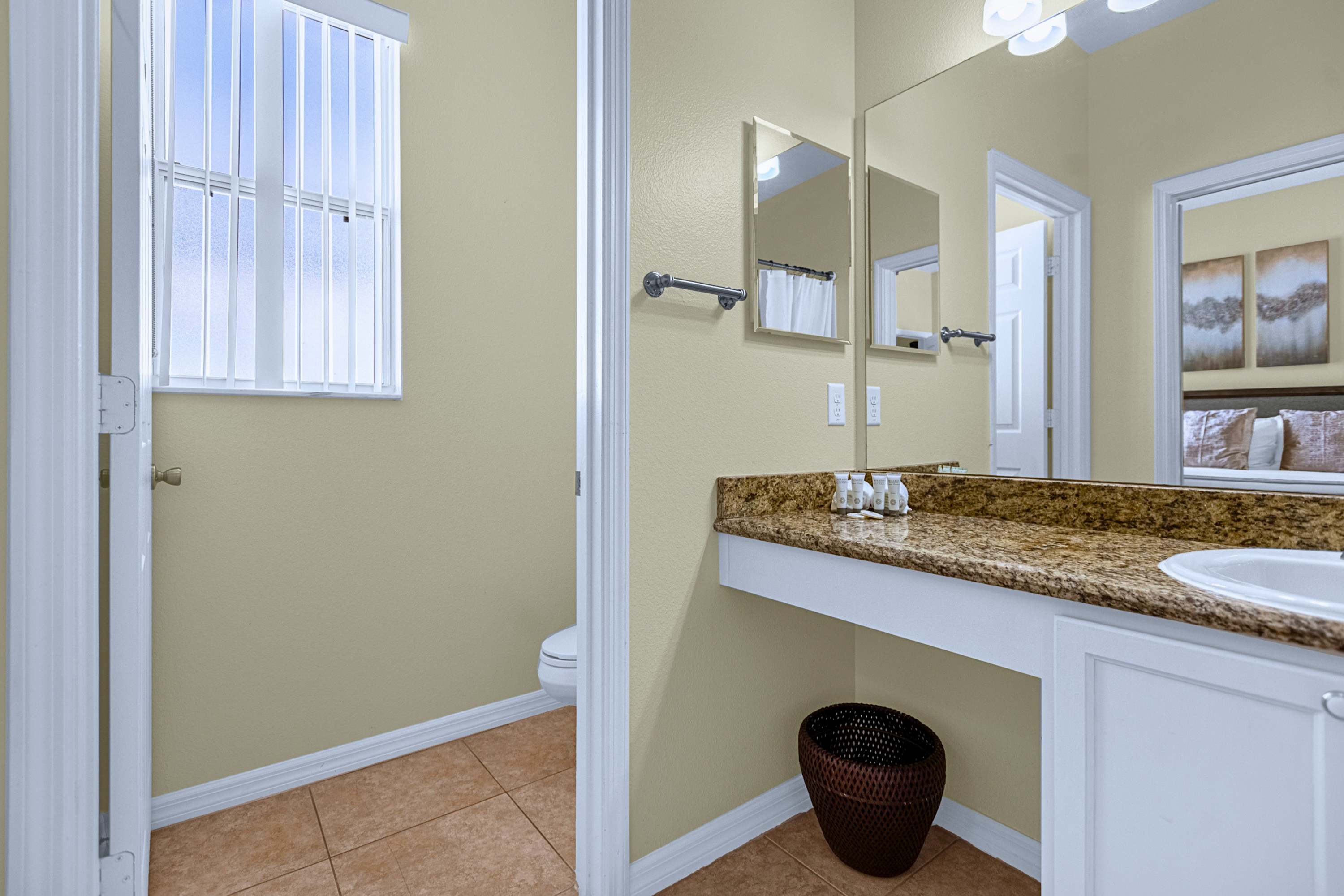 Complete private bathroom featuring a soaking tub, shower, sink & mirror setup.