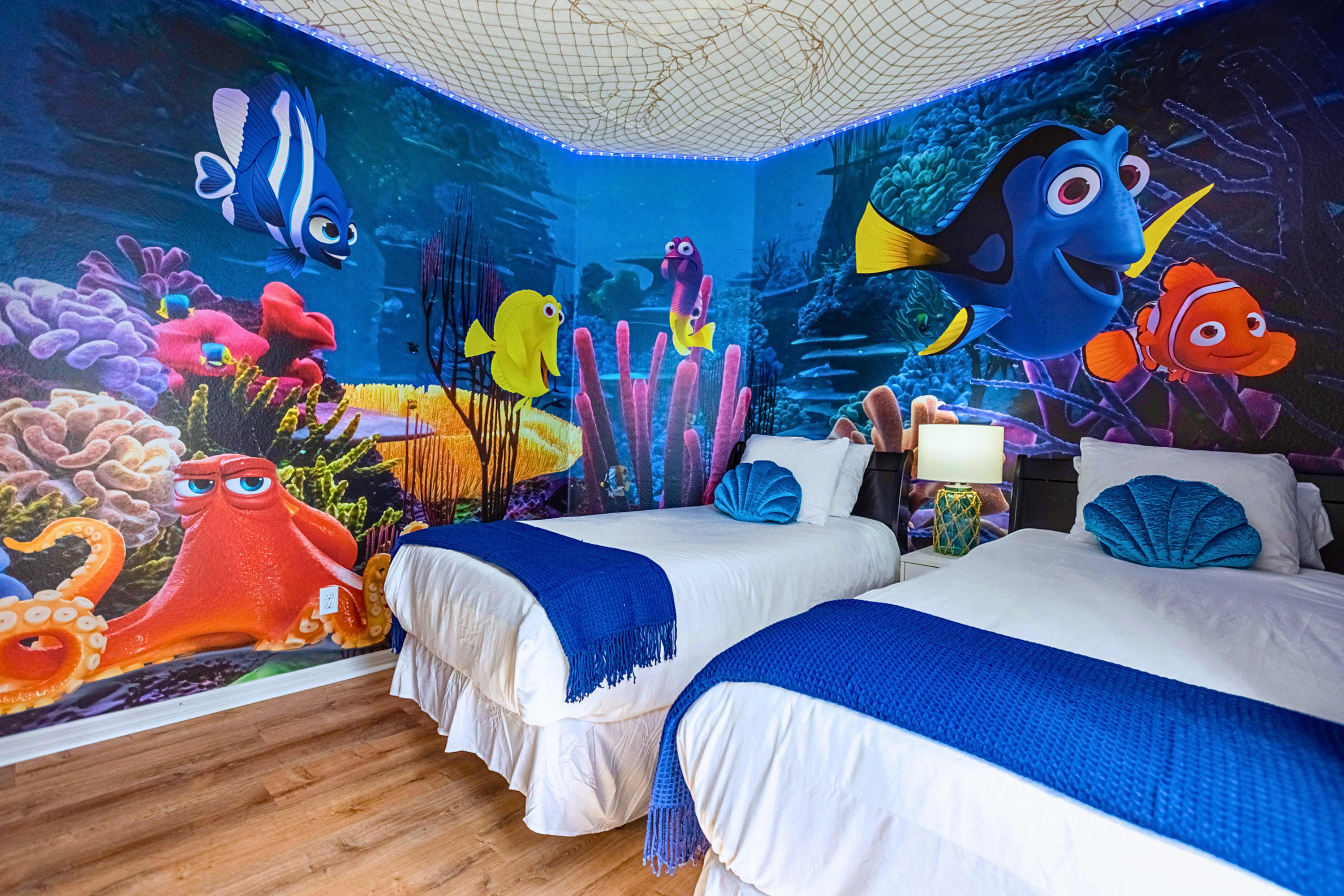 Playful Finding Nemo twin room featuring two single beds and shared lamp.