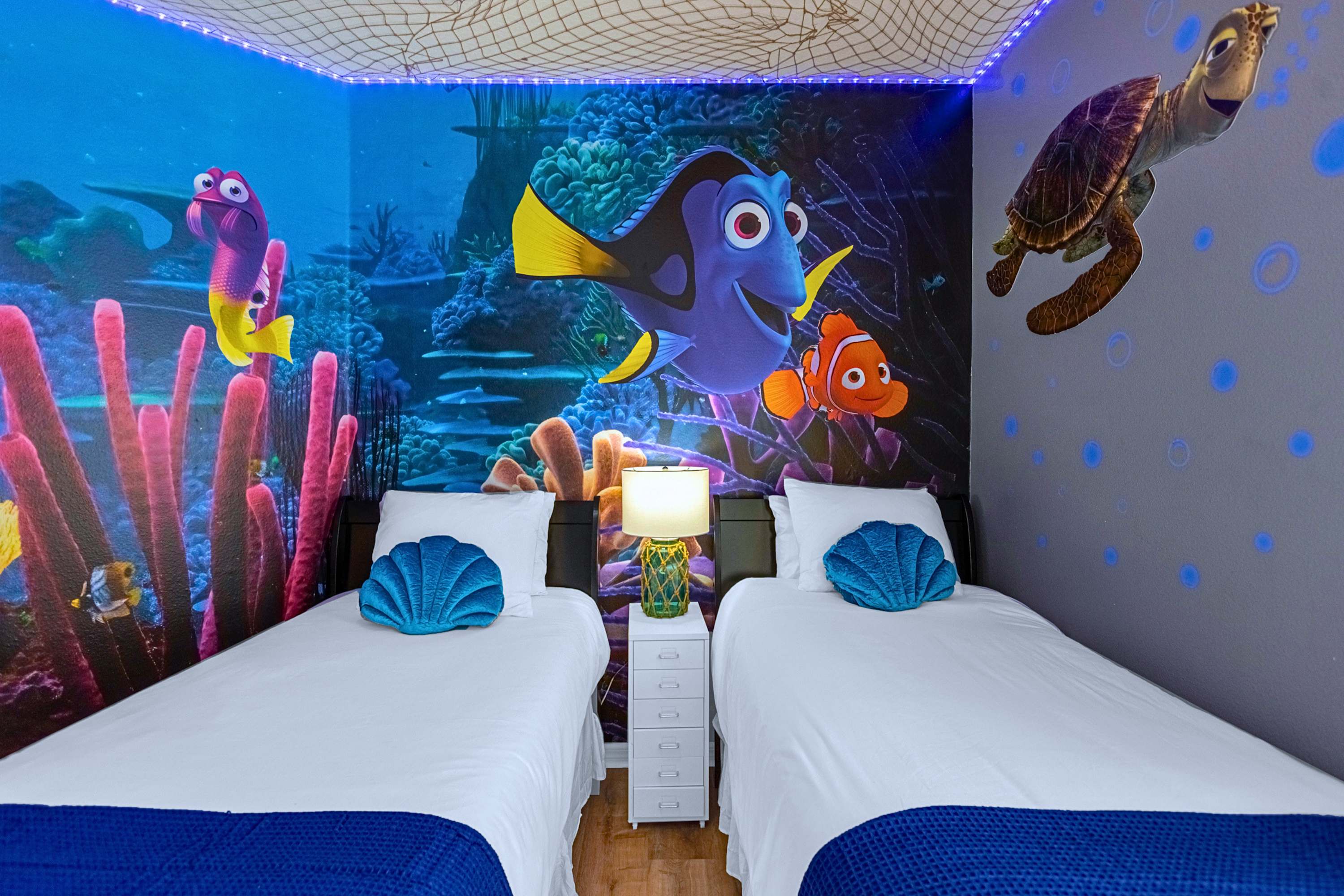 Vibrant Nemo-themed bedroom for kids with two cozy single beds & lamp