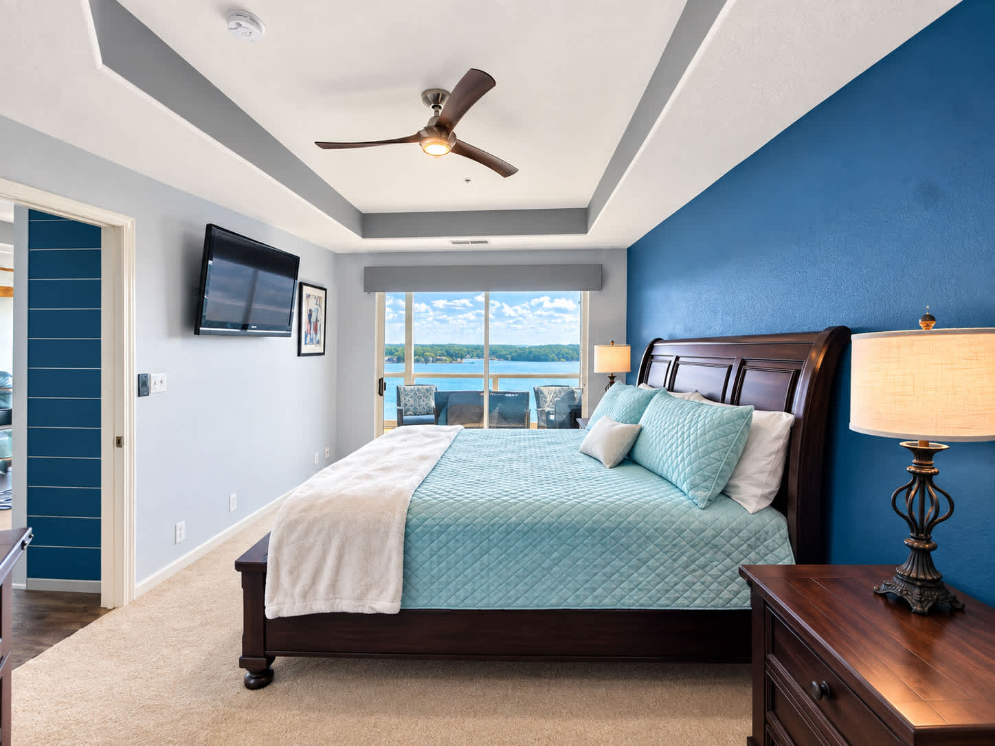 The primary king suite boasts a smart TV, private ensuite, & lakeview balcony​