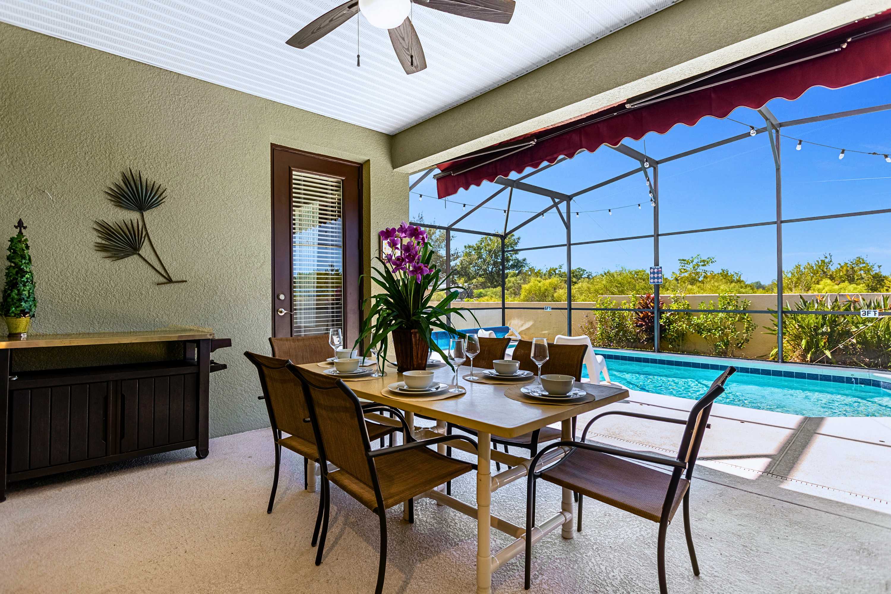 Al fresco meals by the pool with a breezy ceiling fan & easy access