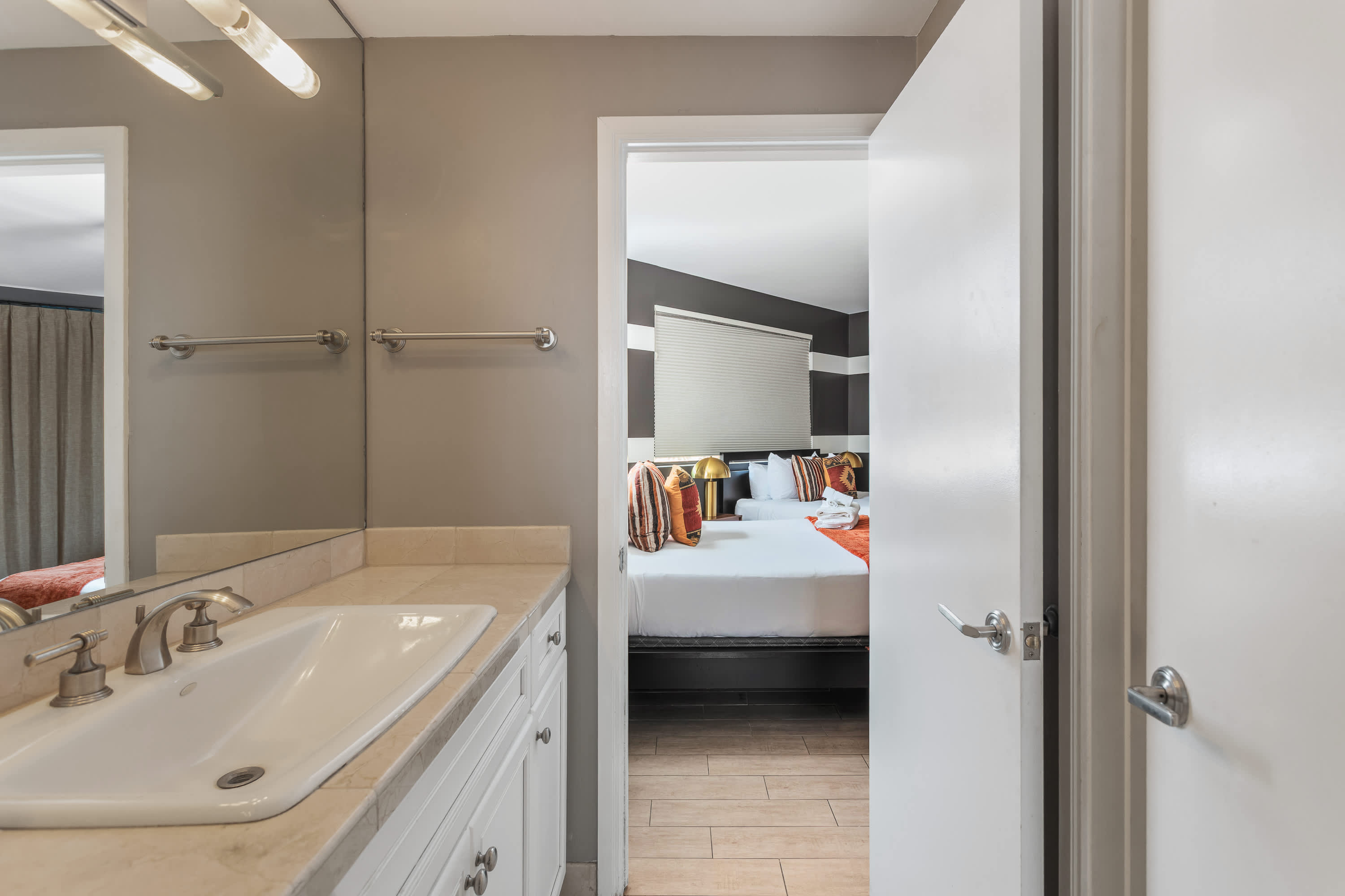 Jack-and-Jill bathroom connecting the 2nd and 3rd bedroom featuring a spacious vanity and shower and tub combo. Making it easy for guests to refresh and get ready with ease.