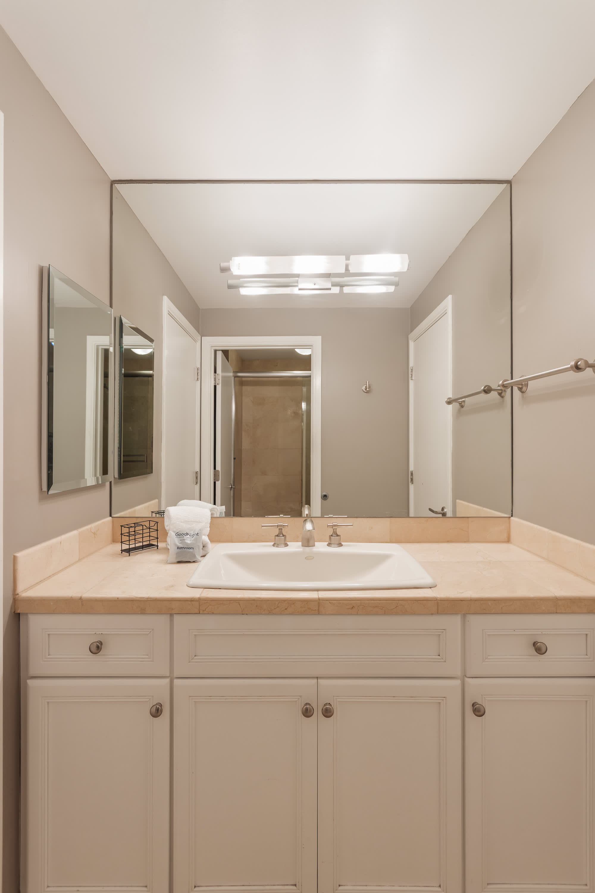 Jack-and-Jill bathroom connecting the 2nd and 3rd bedroom featuring a spacious vanity and shower and tub combo. Making it easy for guests to refresh and get ready with ease.