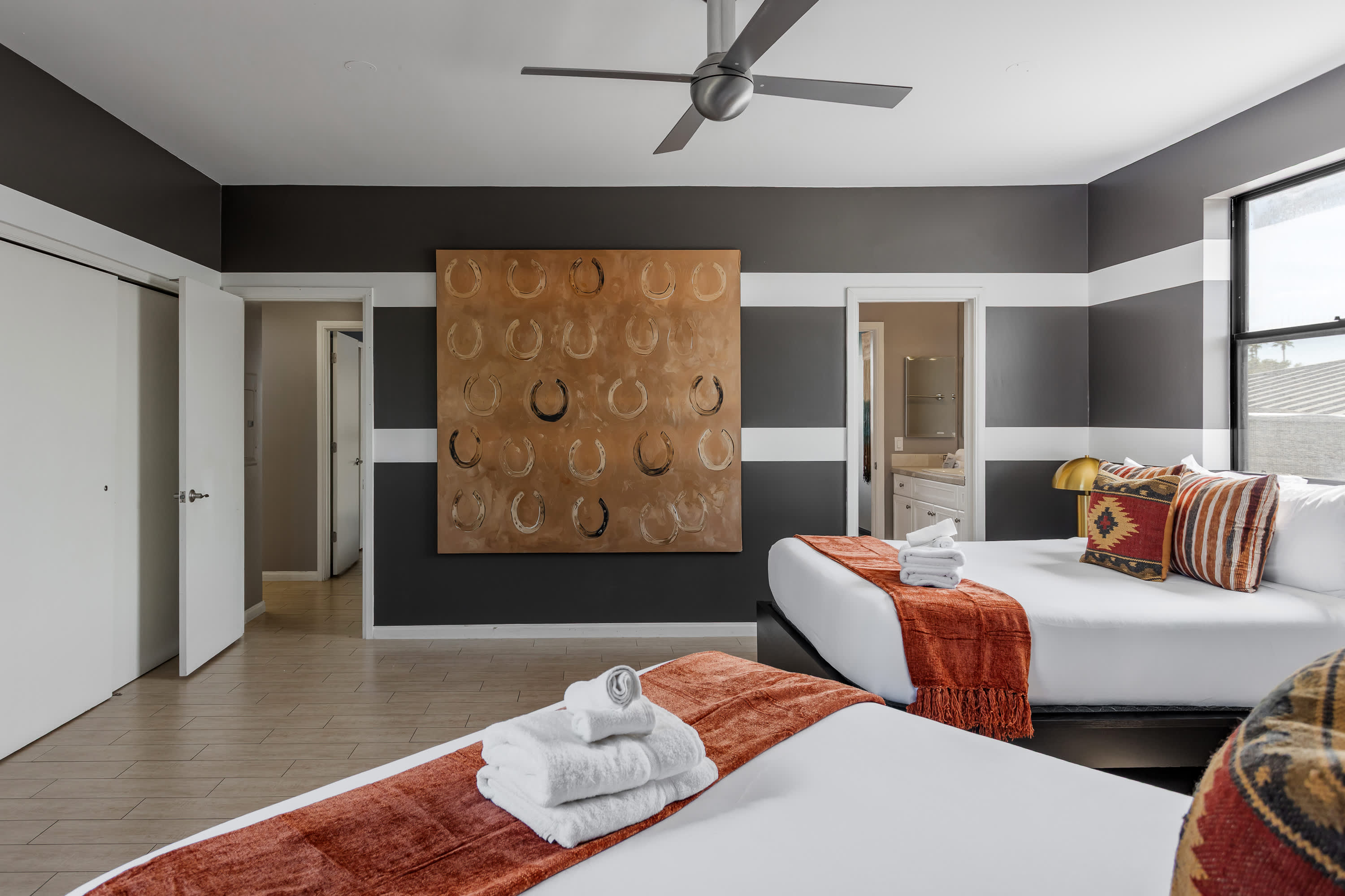 Third bedroom featuring two Queen beds, private balcony access, and access to en-suite jack-n-jill bathroom. Offering plenty of space for groups to relax and recharge.