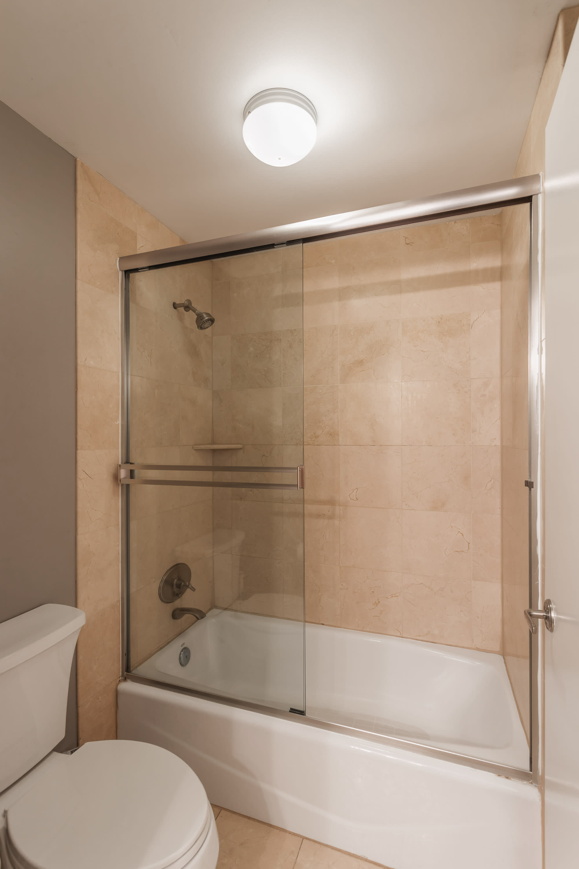 Jack-and-Jill bathroom connecting the 2nd and 3rd bedroom featuring a spacious vanity and shower and tub combo. Making it easy for guests to refresh and get ready with ease.