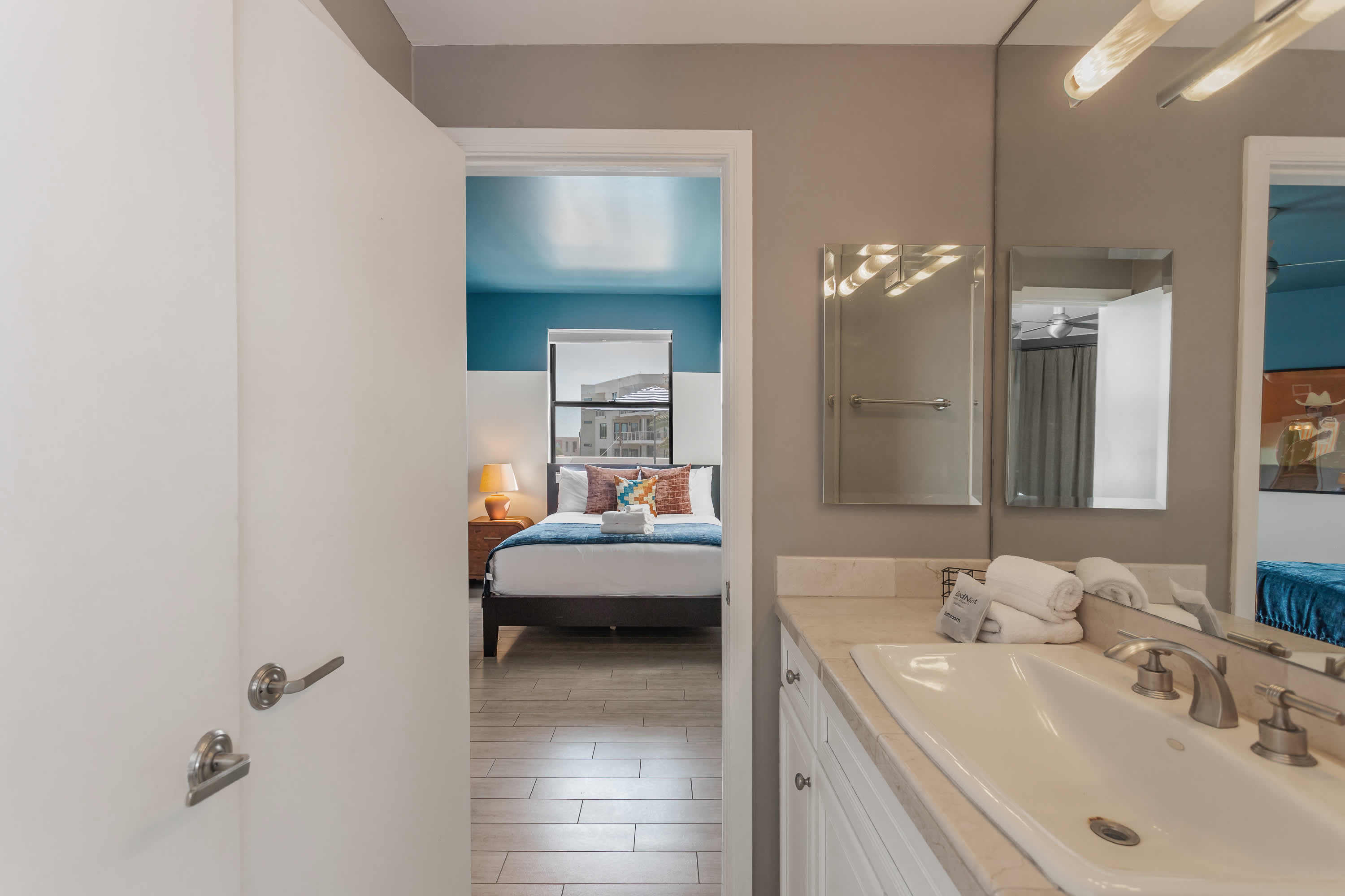 Jack-and-Jill bathroom connecting the 2nd and 3rd bedroom featuring a spacious vanity and shower and tub combo. Making it easy for guests to refresh and get ready with ease.
