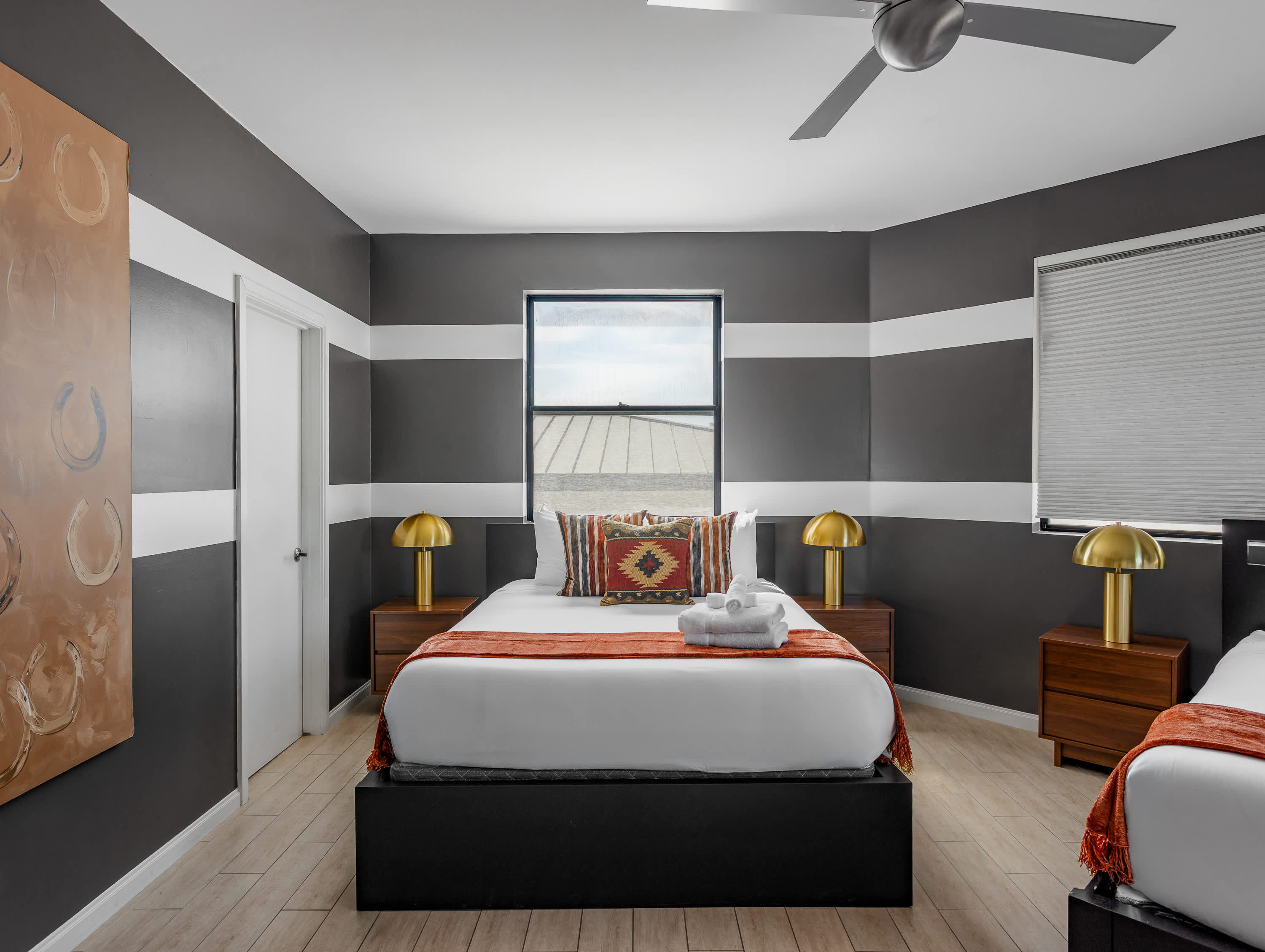 Third bedroom featuring two Queen beds, private balcony access, and access to en-suite jack-n-jill bathroom. Offering plenty of space for groups to relax and recharge.