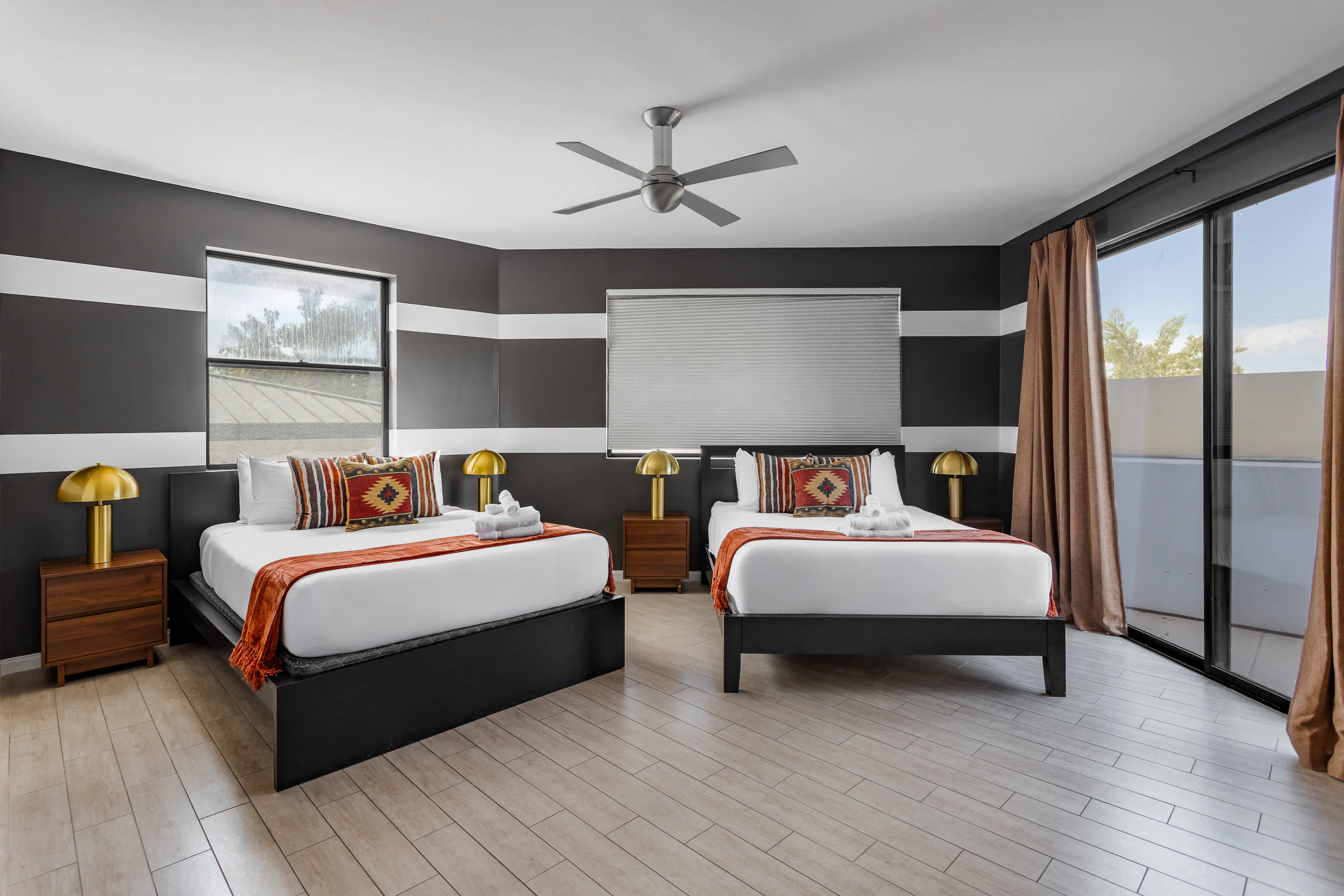 Third bedroom featuring two Queen beds, private balcony access, and access to en-suite jack-n-jill bathroom. Offering plenty of space for groups to relax and recharge.