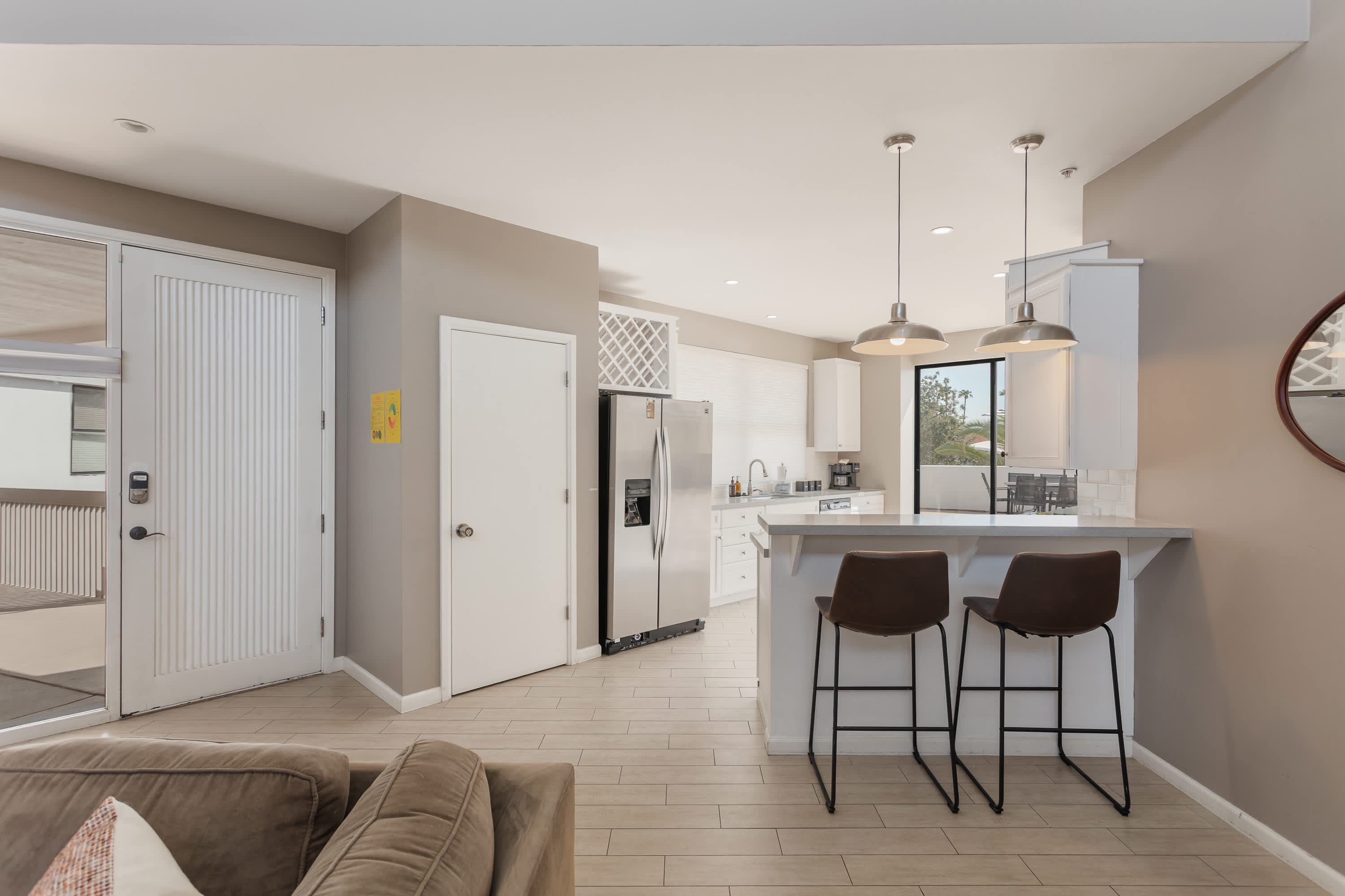 Modern kitchen featuring stainless steel appliances, generous counter space, and a breakfast bar perfect for casual dining and morning coffee.