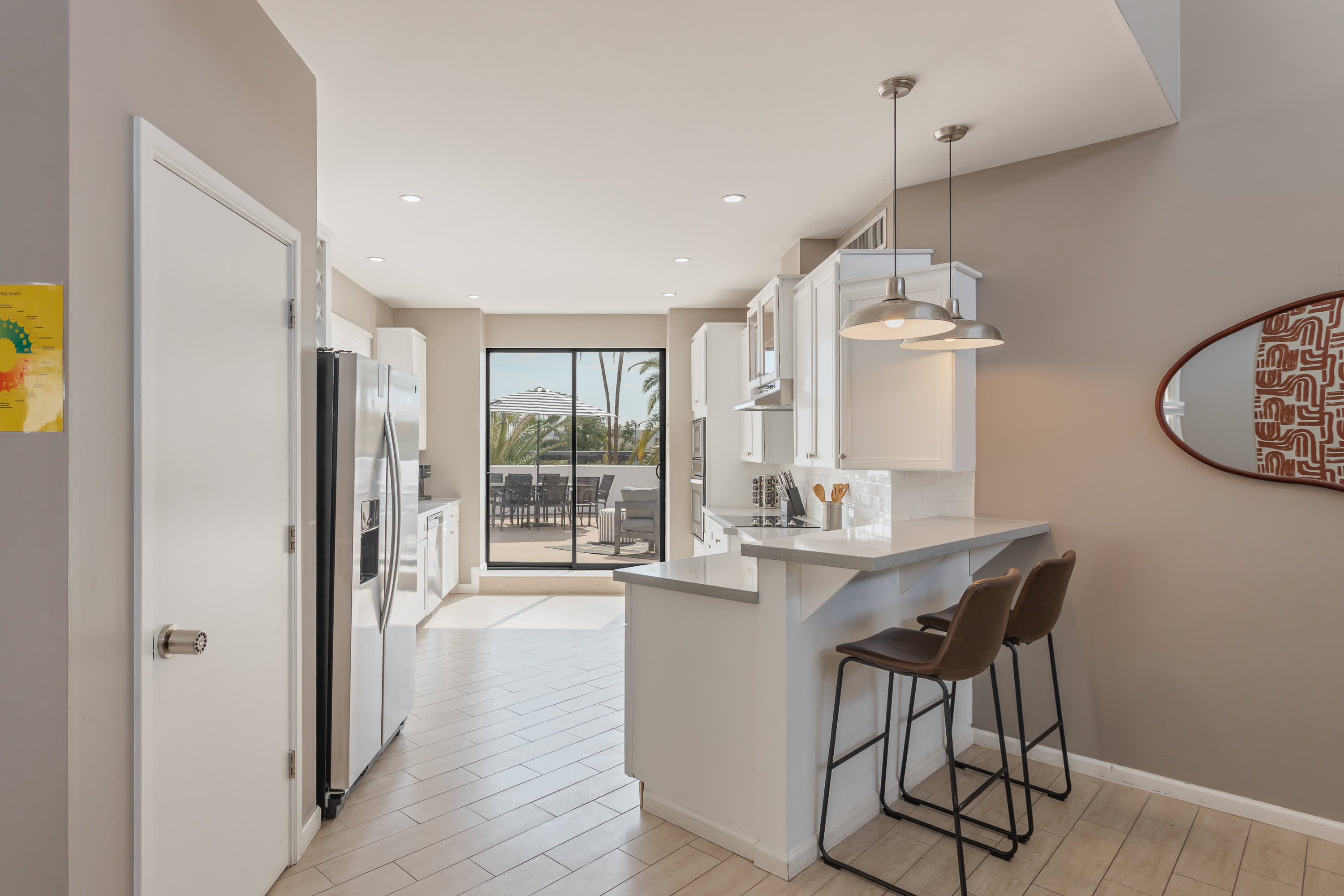 Modern kitchen featuring stainless steel appliances, generous counter space, and a breakfast bar perfect for casual dining and morning coffee.