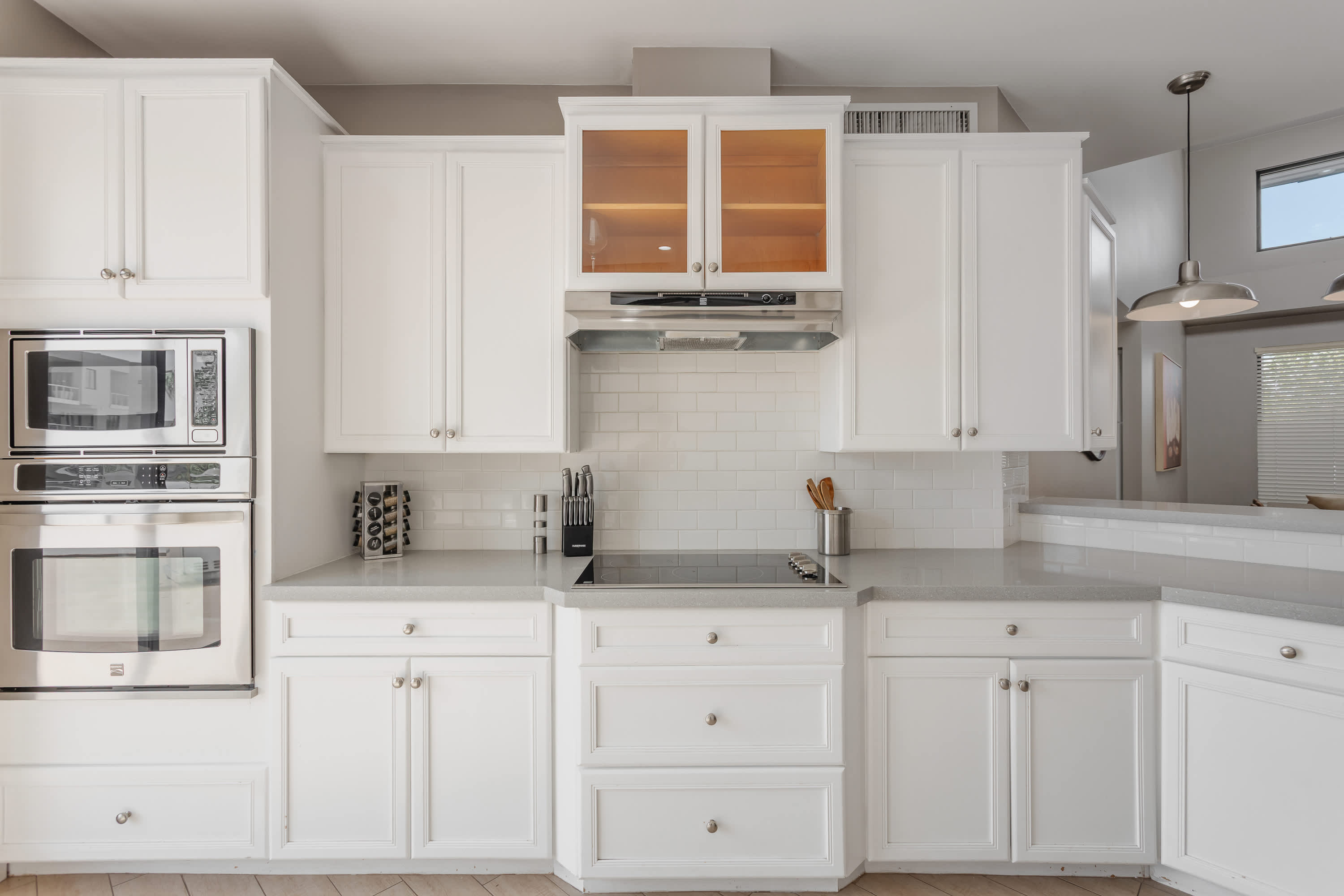 Modern kitchen featuring stainless steel appliances, generous counter space, and a breakfast bar perfect for casual dining and morning coffee.
