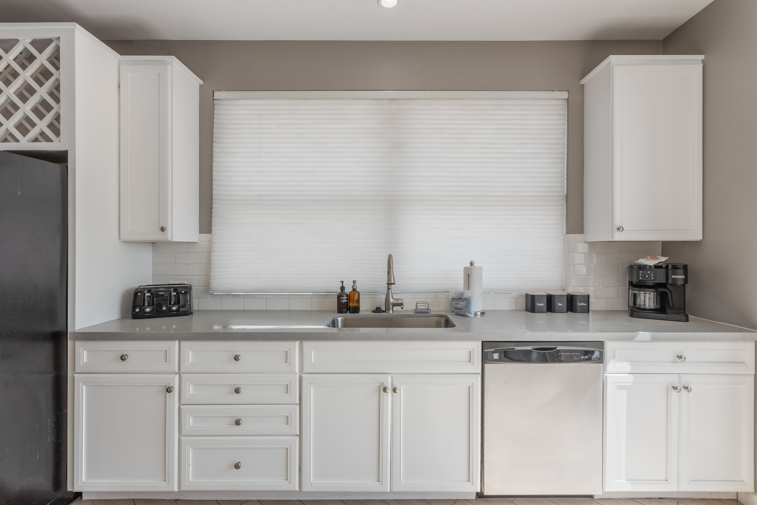 Modern kitchen featuring stainless steel appliances, generous counter space, and a breakfast bar perfect for casual dining and morning coffee.