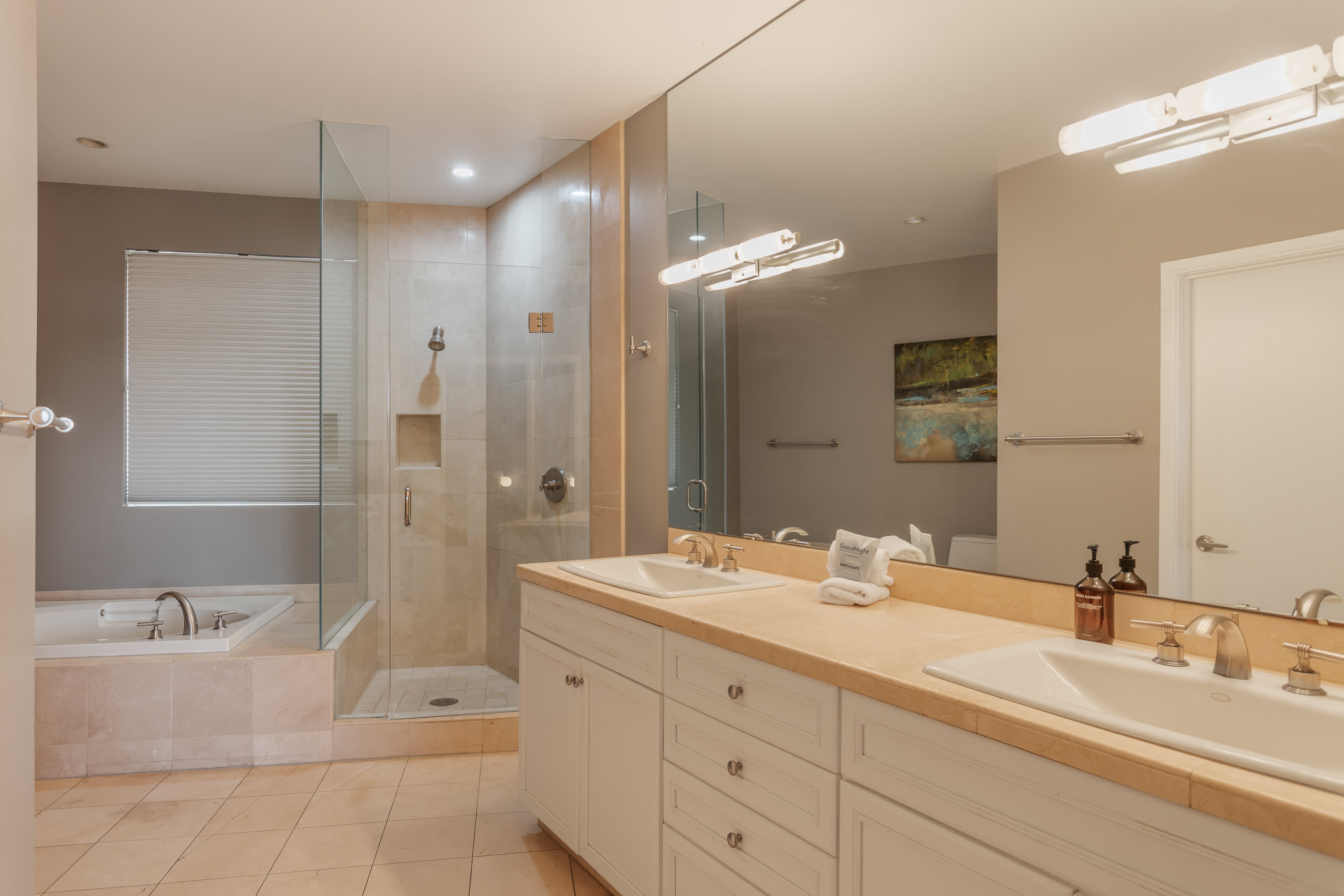 Spa-inspired primary bathroom featuring a soaking tub, walk-in shower, dual vanities, and a spacious layout designed for comfort and relaxation.