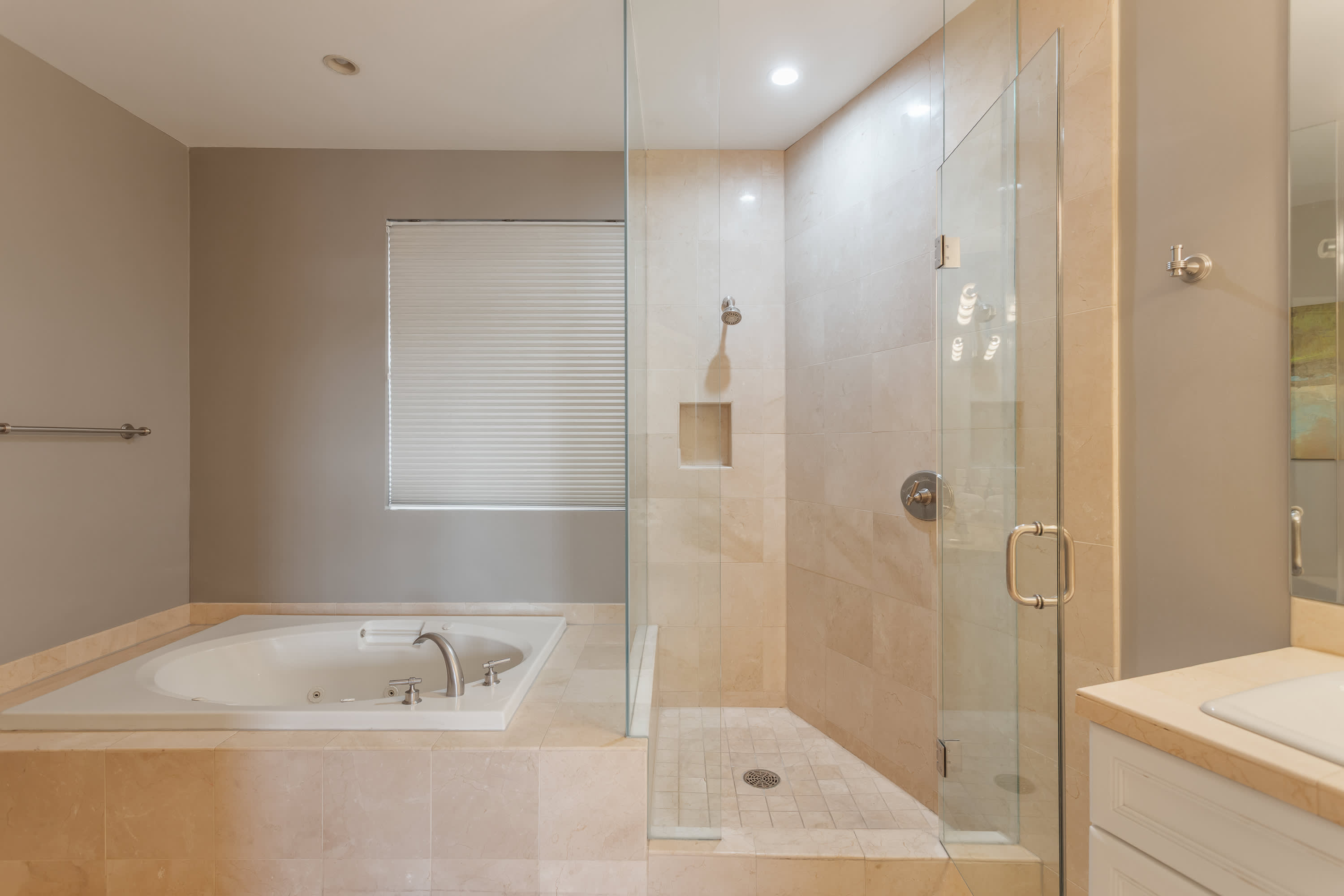 Spa-inspired primary bathroom featuring a soaking tub, walk-in shower, dual vanities, and a spacious layout designed for comfort and relaxation.