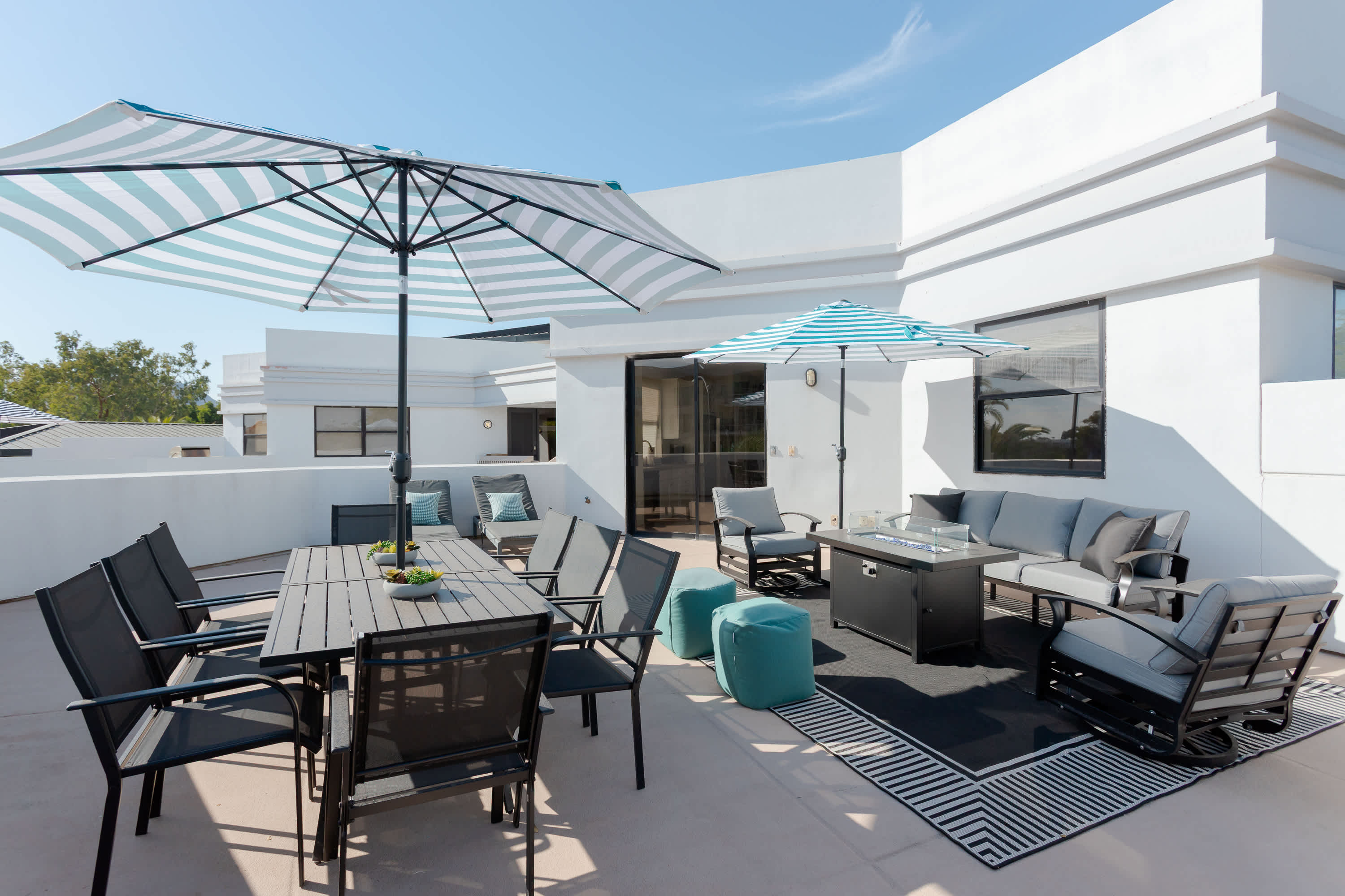 Private balcony with lounge seating with built in fire pit table, a BBQ grill, outdoor dining area for 8, sun loungers, and plenty of room to relax outdoors in the Scottsdale sunshine.