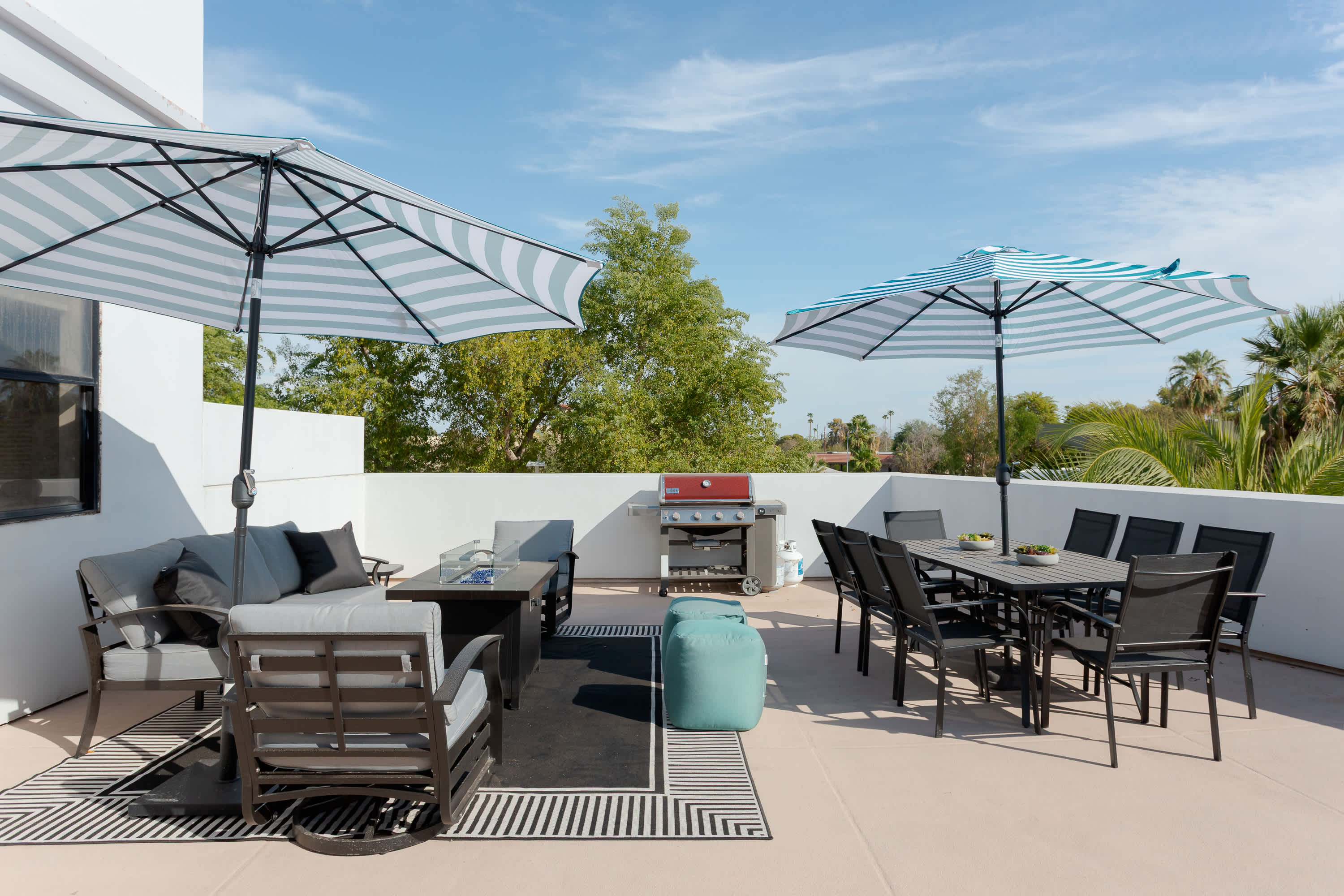 Private balcony with lounge seating with built in fire pit table, a BBQ grill, outdoor dining area for 8, sun loungers, and plenty of room to relax outdoors in the Scottsdale sunshine.
