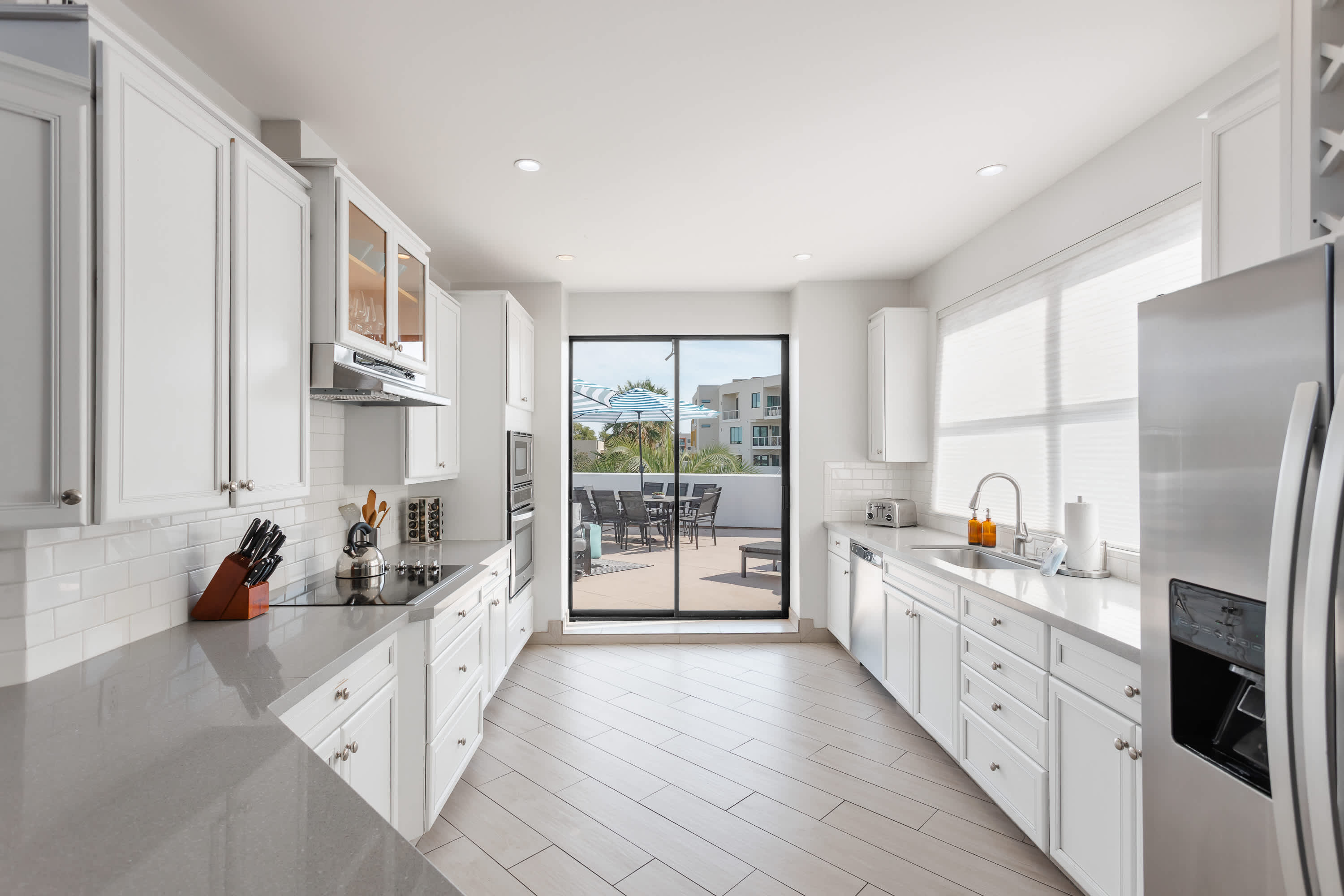Sleek, well-equipped kitchen with stainless steel appliances, ample prep space, bar seating, and everything you need for meals, snacks, and easy entertaining.