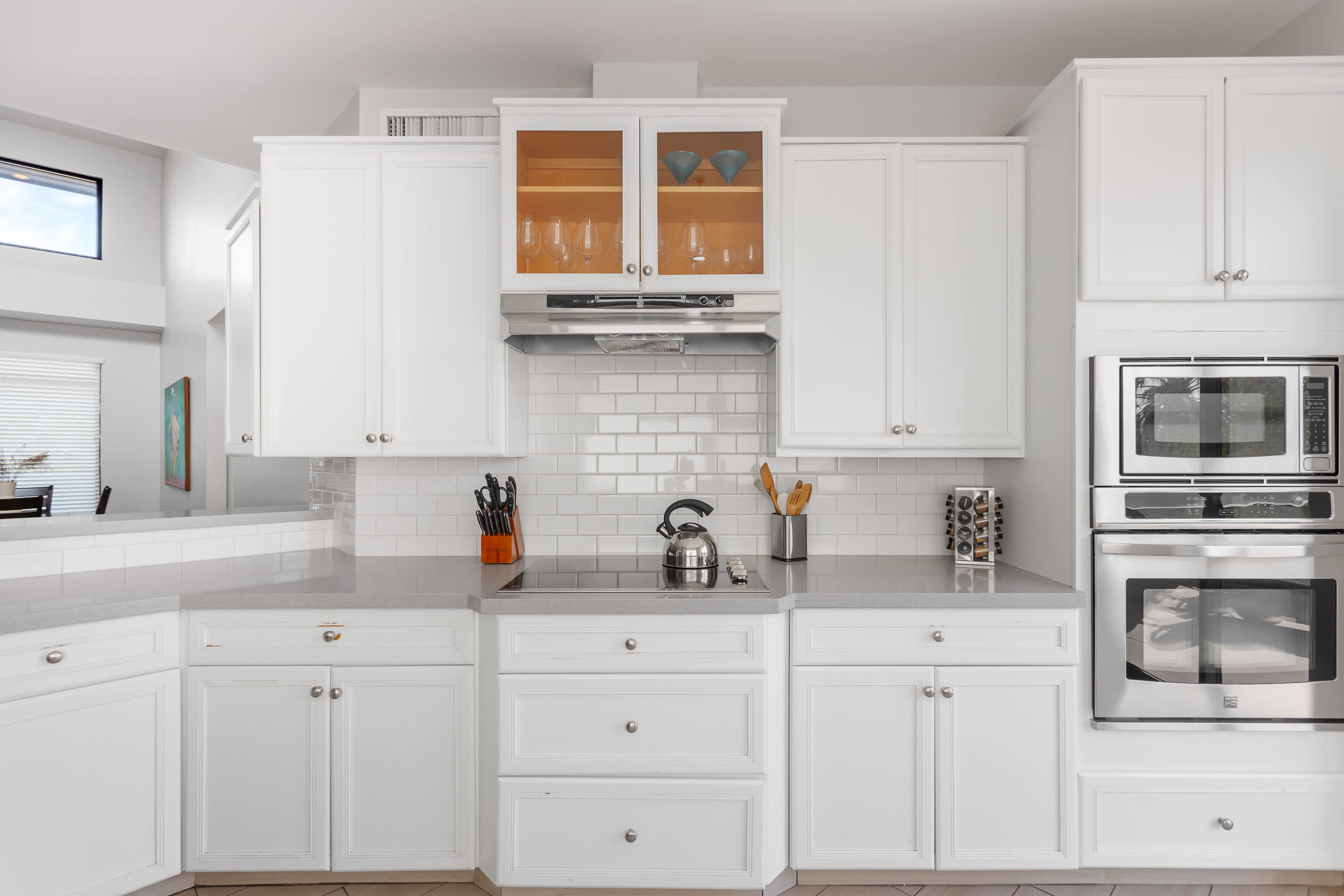Sleek, well-equipped kitchen with stainless steel appliances, ample prep space, bar seating, and everything you need for meals, snacks, and easy entertaining.