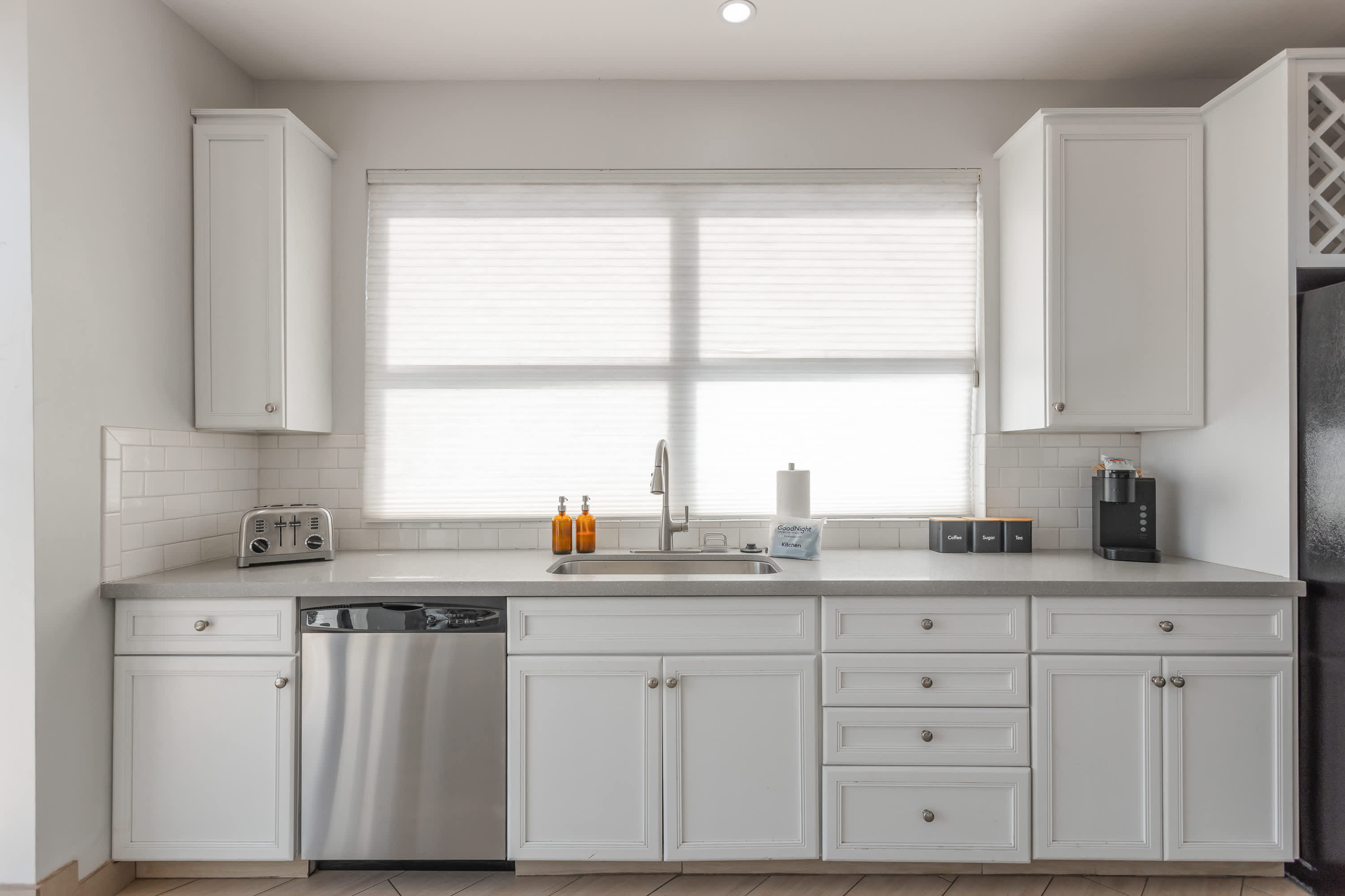 Sleek, well-equipped kitchen with stainless steel appliances, ample prep space, bar seating, and everything you need for meals, snacks, and easy entertaining.