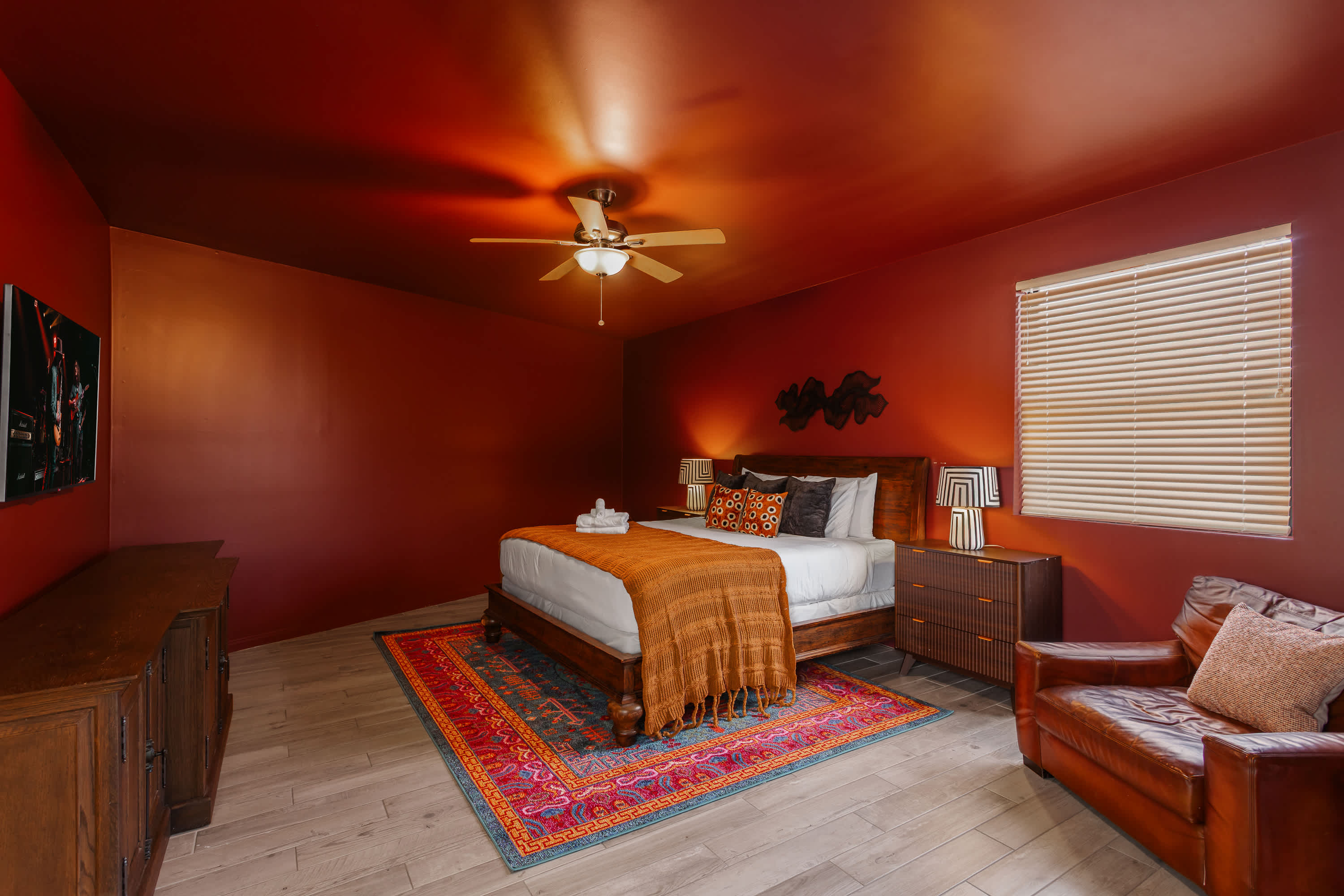 Spacious primary suite with a King bed, Smart TV, cozy sitting area, private balcony access, and an en-suite bathroom for added privacy and comfort.