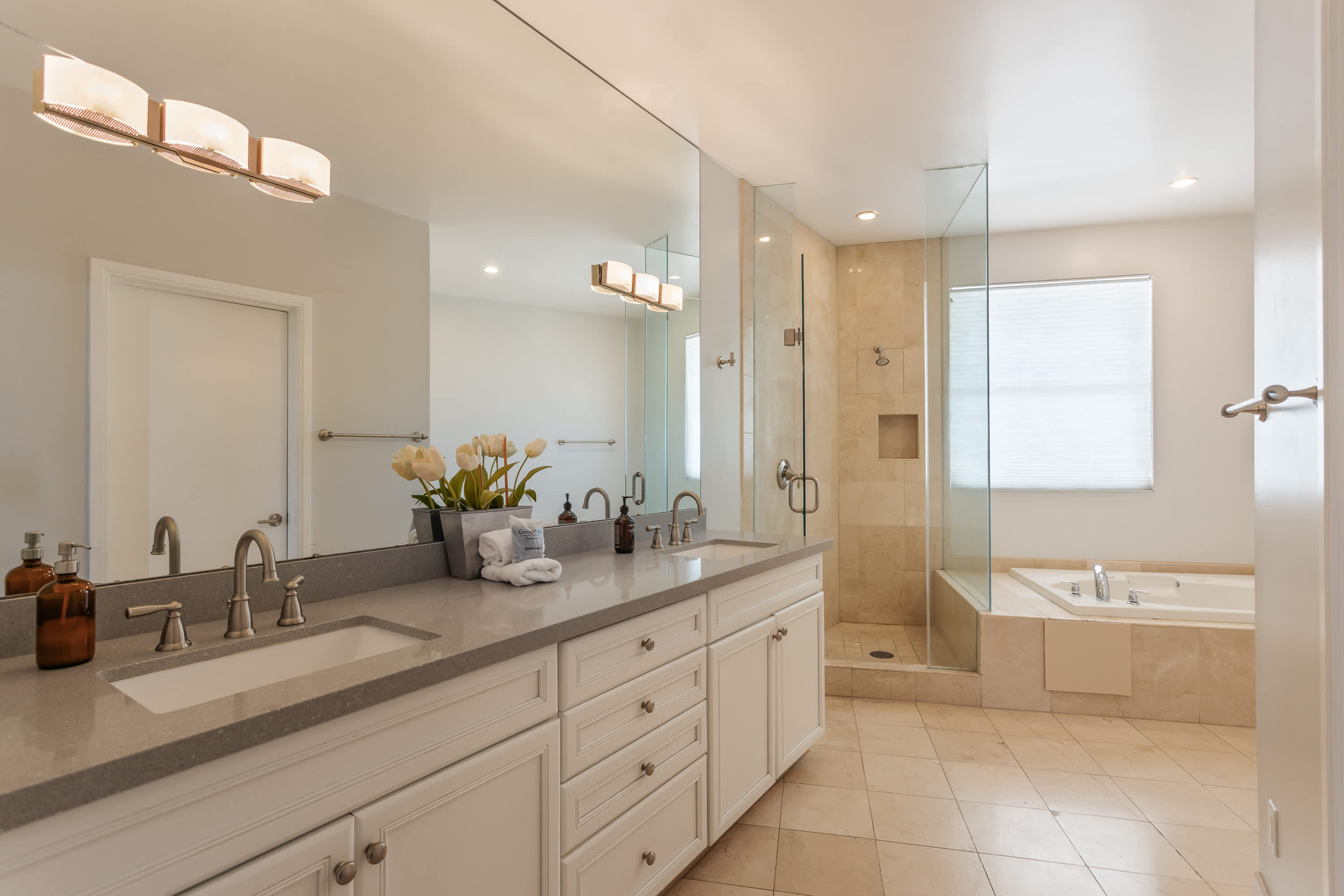 Roomy primary bathroom with dual vanities, a soaking tub, walk-in shower, and plenty of space to refresh and unwind.