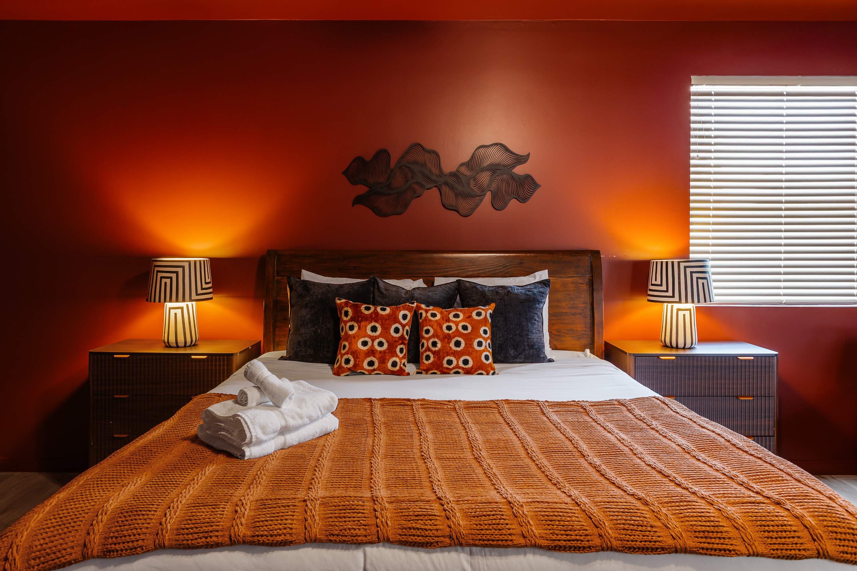 Spacious primary suite with a King bed, Smart TV, cozy sitting area, private balcony access, and an en-suite bathroom for added privacy and comfort.