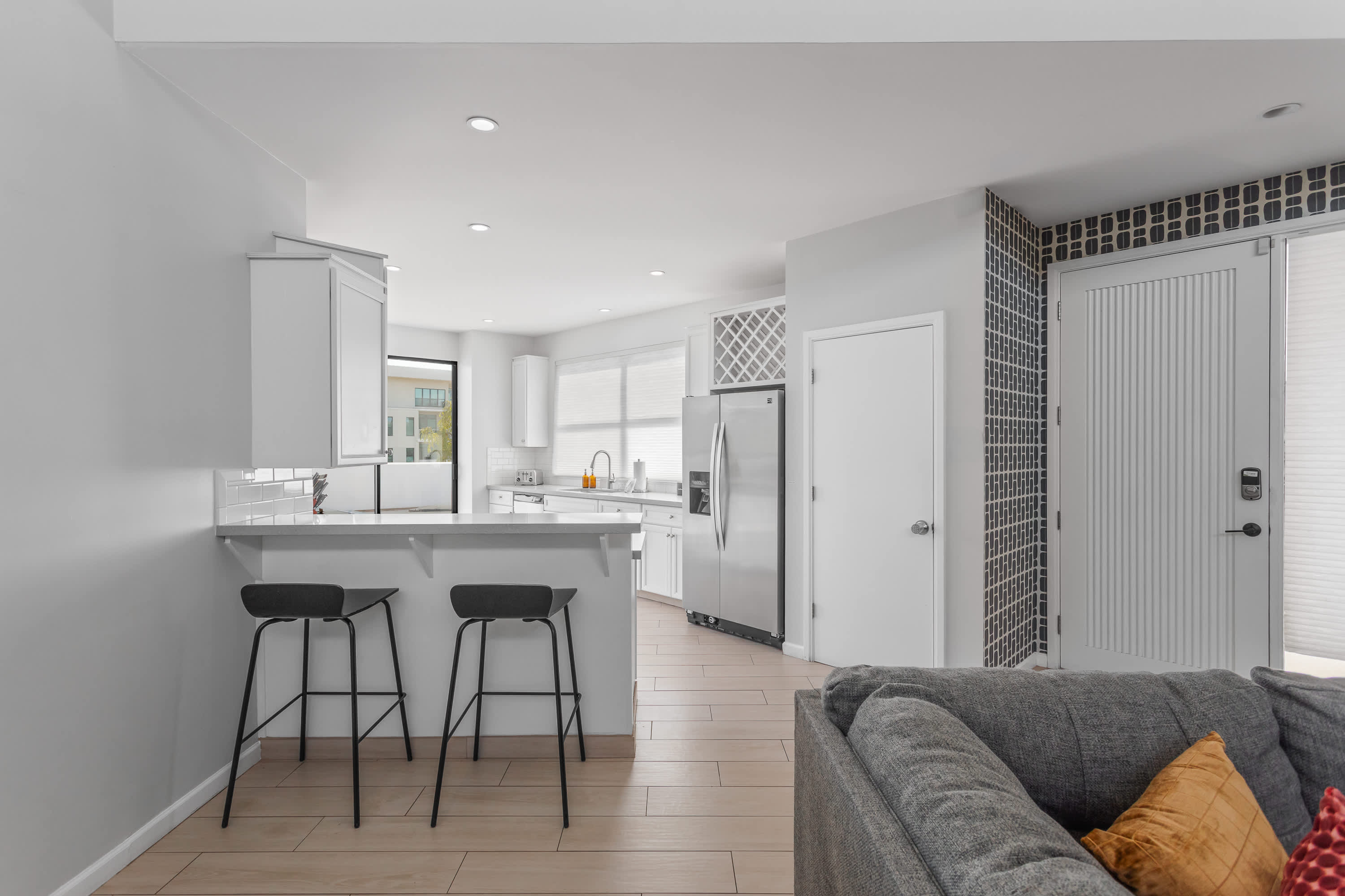Sleek, well-equipped kitchen with stainless steel appliances, ample prep space, bar seating, and everything you need for meals, snacks, and easy entertaining.