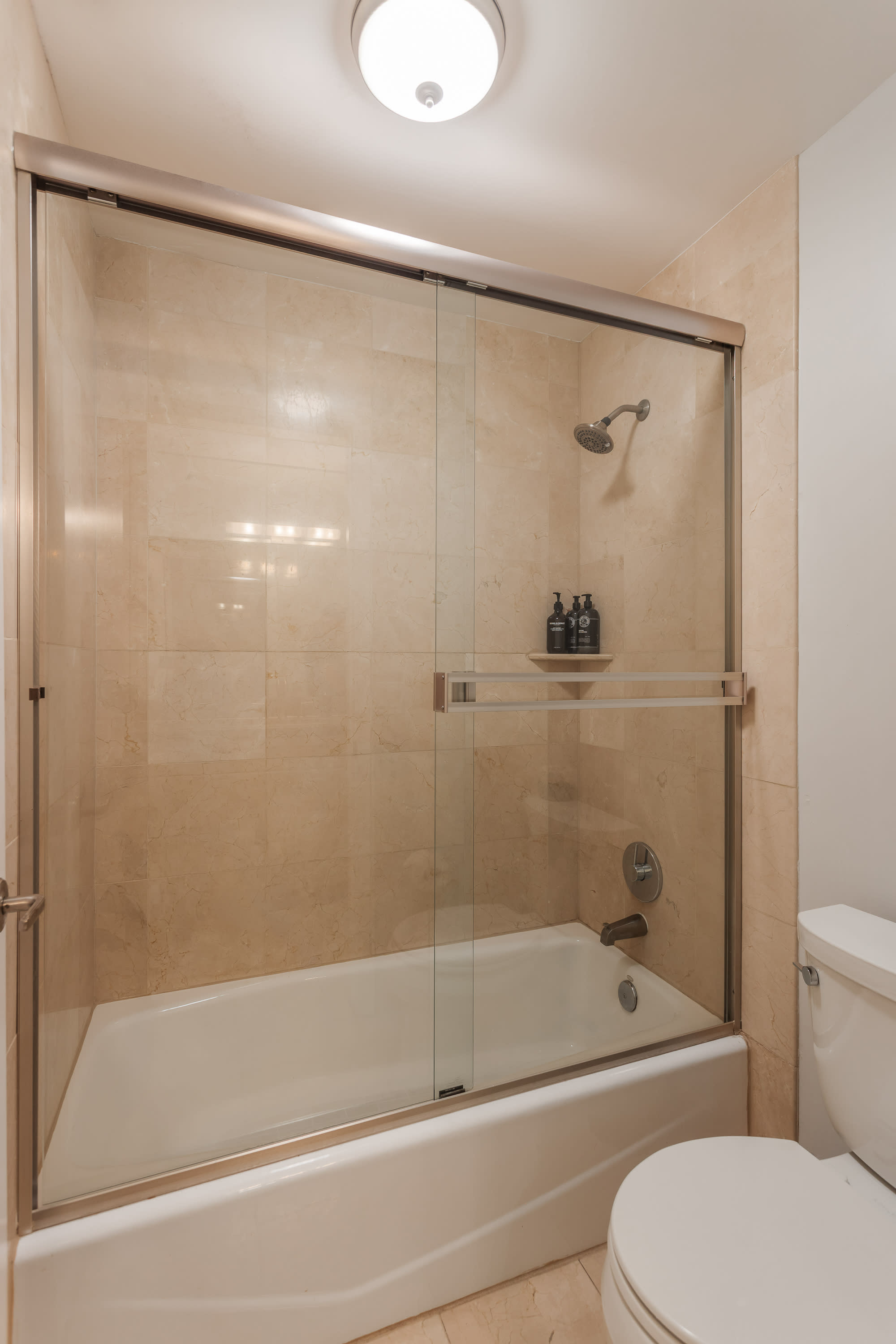Convenient Jack-and-Jill bathroom with a spacious vanity, shower and tub combo, and shared access, ideal for guests staying in the adjoining bedrooms.