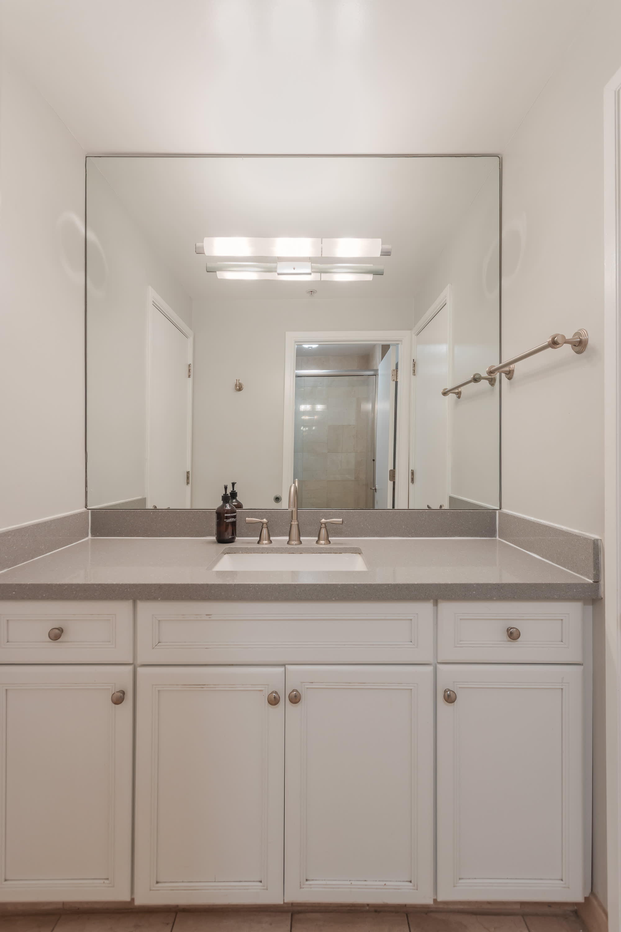 Convenient Jack-and-Jill bathroom with a spacious vanity, shower and tub combo, and shared access, ideal for guests staying in the adjoining bedrooms.