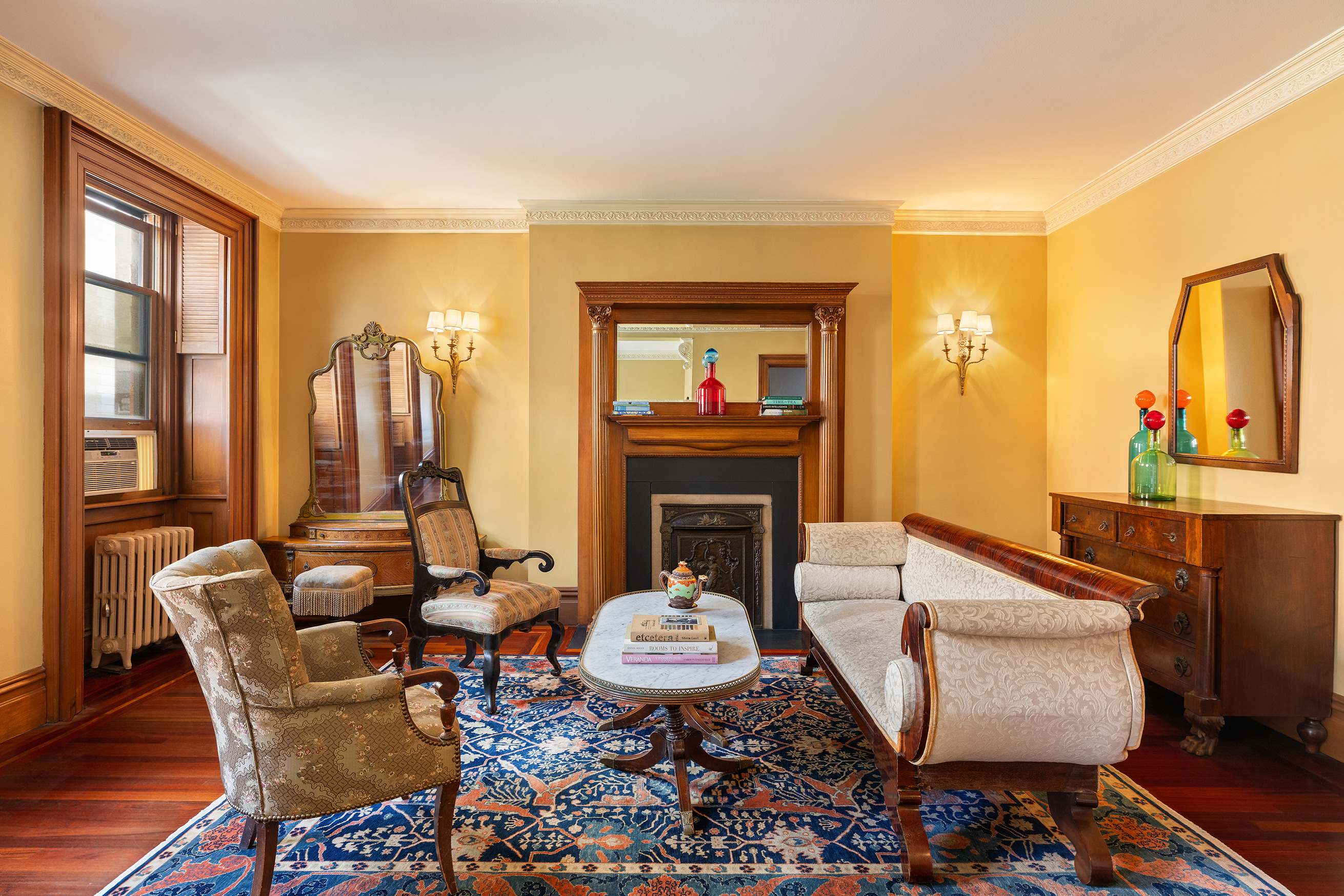A cozy lobby with a fireplace, seating area, and decorative items.