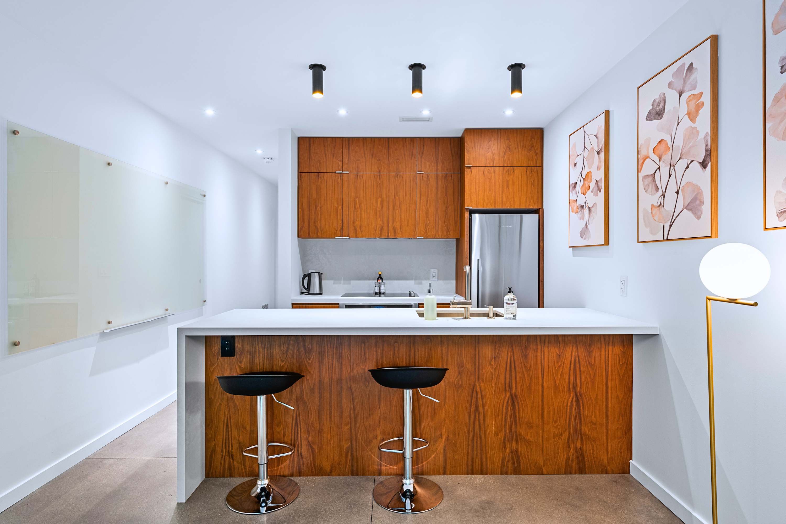 Chef's kitchen featuring custom cabinetry, integrated stove, deep sink, and bar seating.